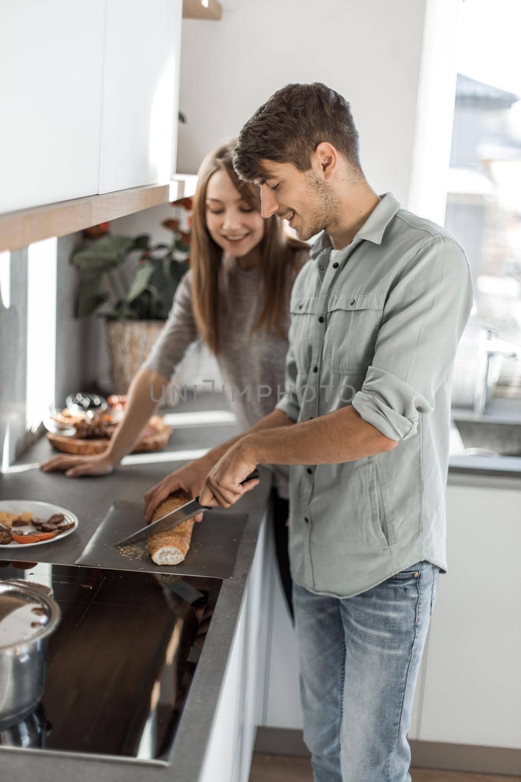 beautiful young couple is preparing Breakfast in their kitchen.
