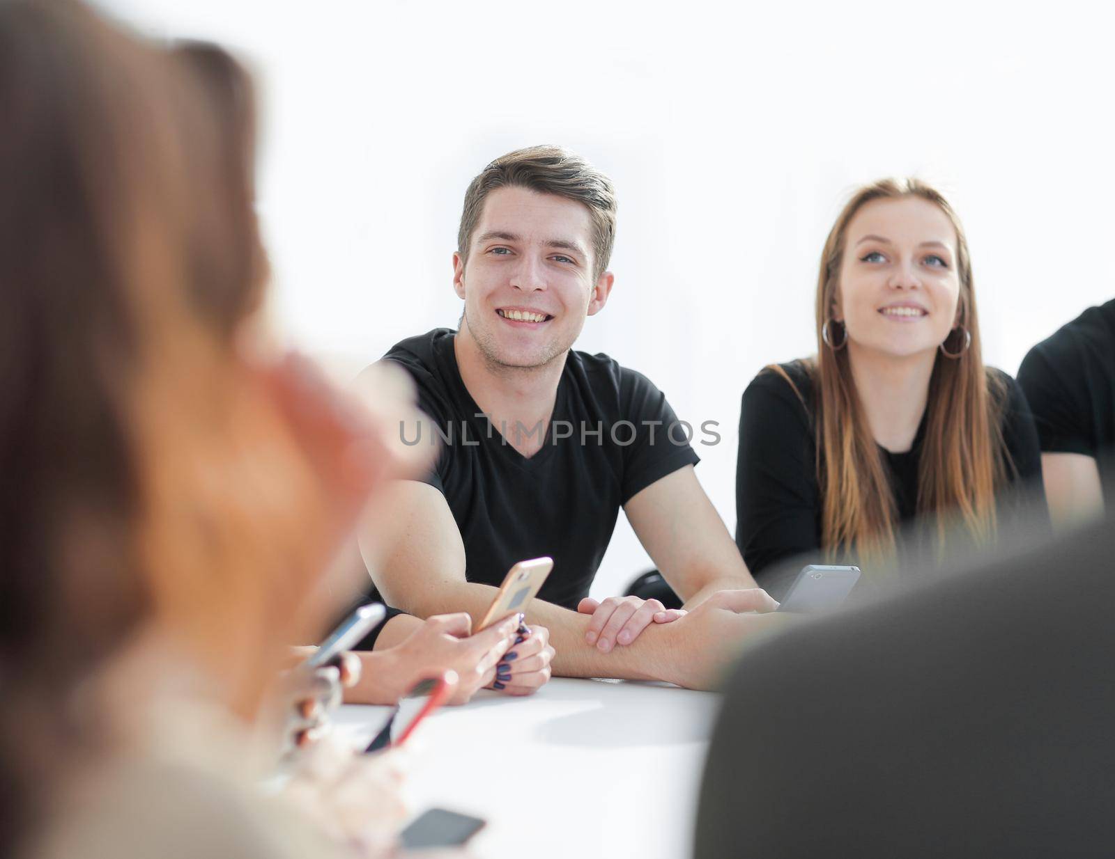 close up. group of young people sitting at a round table