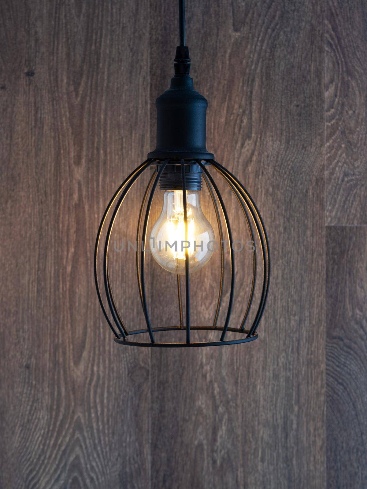 decorative chandelier on a background of a wooden wall. Chandelier Lighting. The lamp with LED lamps.