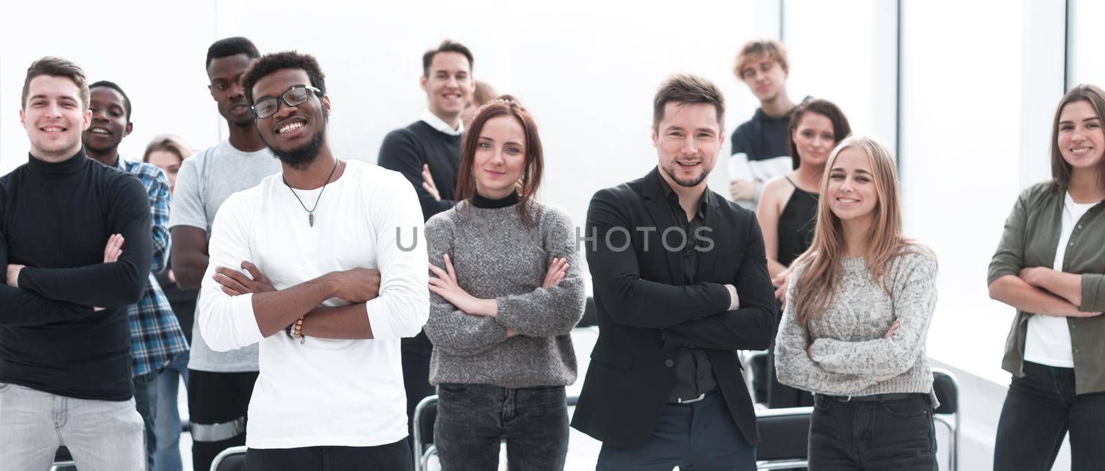 group of confident young people standing in a conference room by asdf