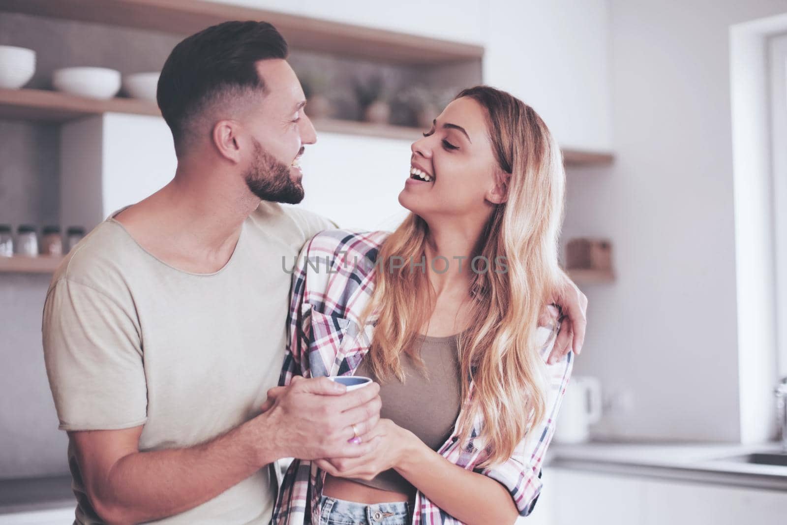 close up. happy young couple in kitchen in good morning time