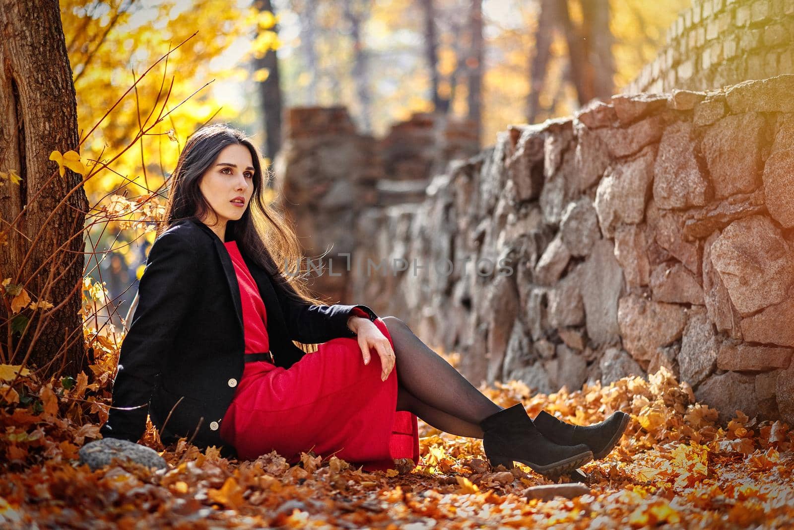 Young beautiful woman posing in autumn foliage outdoor by Rom4ek