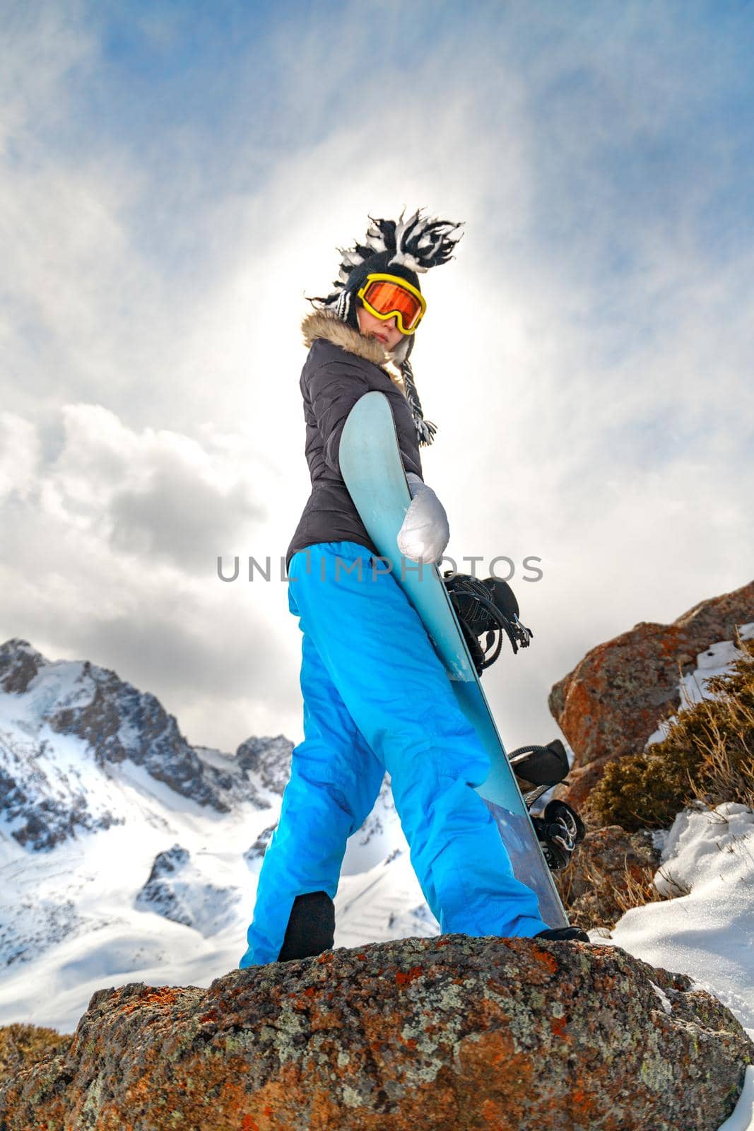 Side view snowboarder in high mountain. Copy space