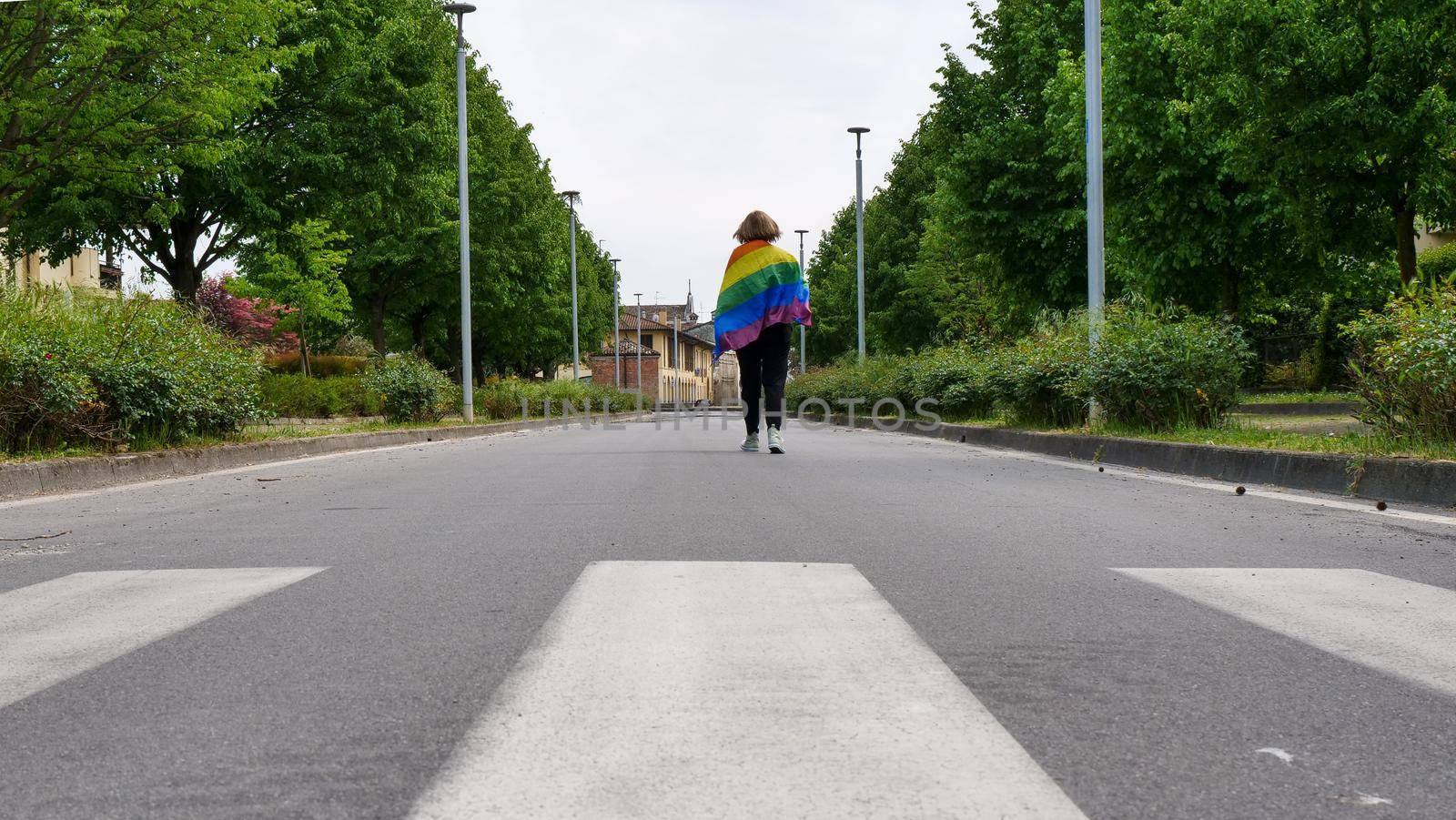 Bisexual, lesbian, female, transgender walk with LGBT flag on the road on a day and celebrate Bisexuality Day or National Coming Out Day