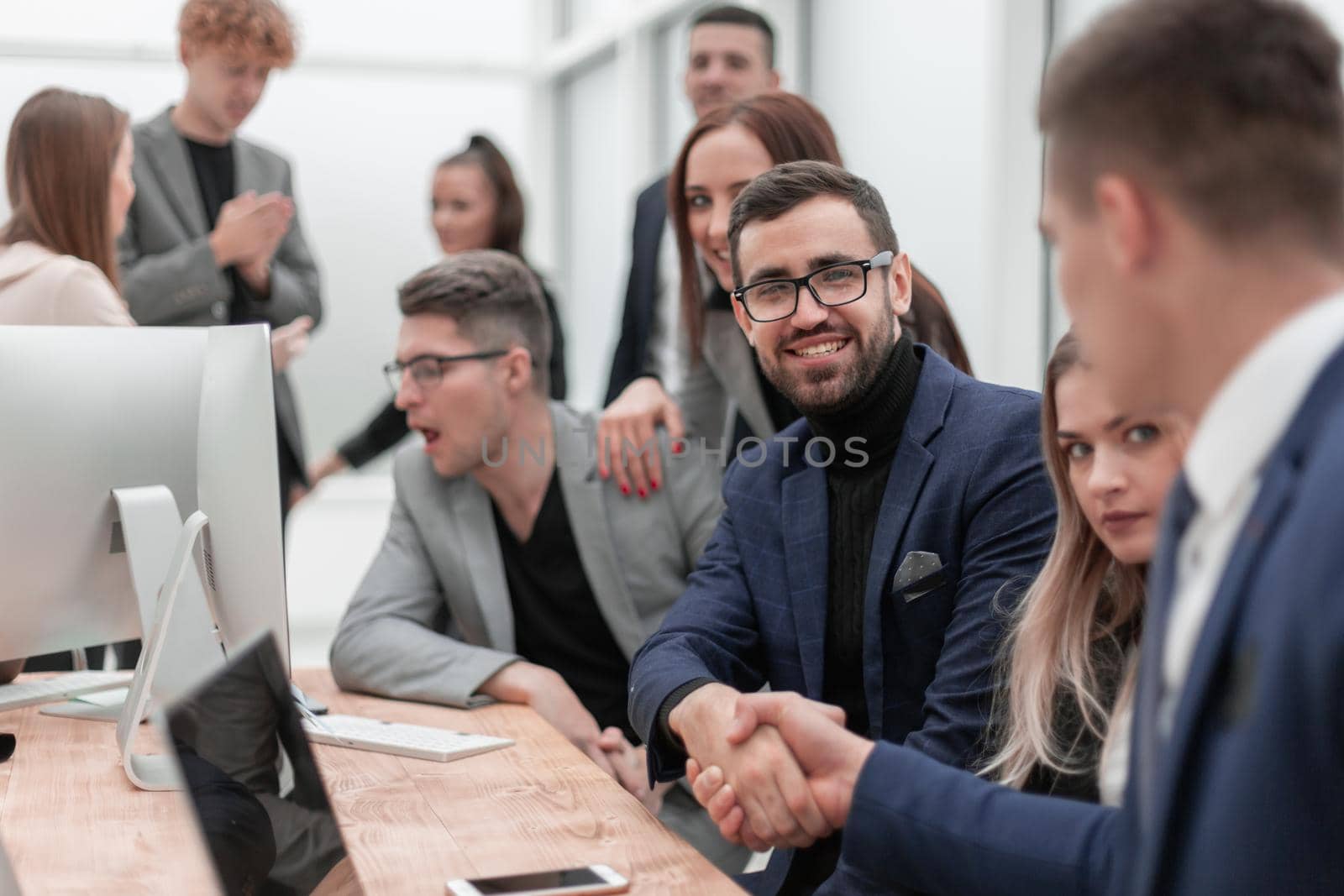 business people shaking hands sitting at the office Desk. the concept of cooperation