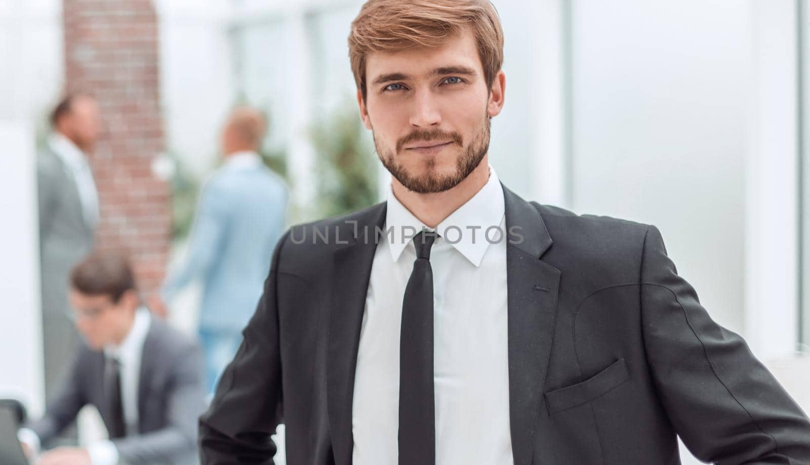 close up. smiling businessman standing in his office. photo with copy space
