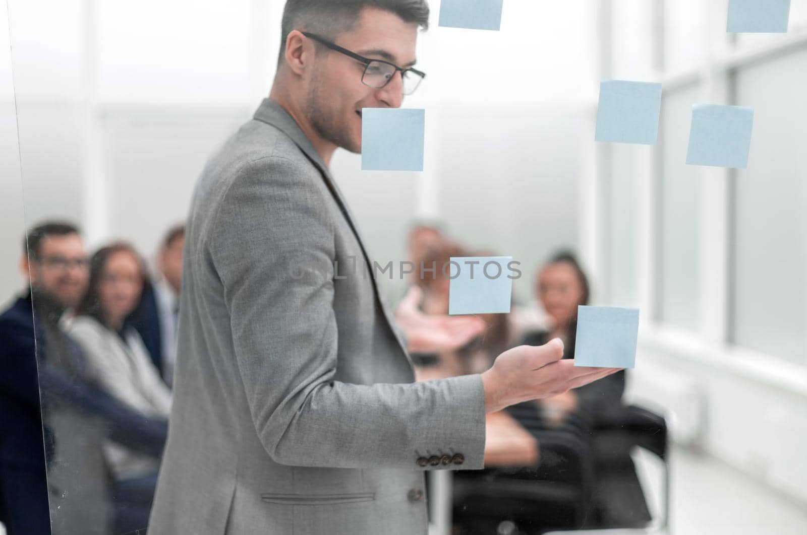 head of the project, pointing to the sticky notes during a work meeting by asdf