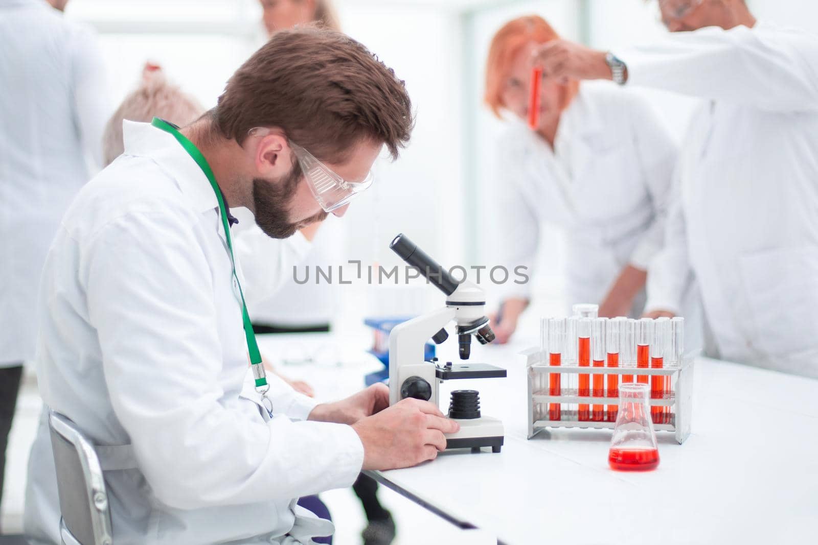 close up. young scientist sitting at a table in the laboratory. concept of health protection.