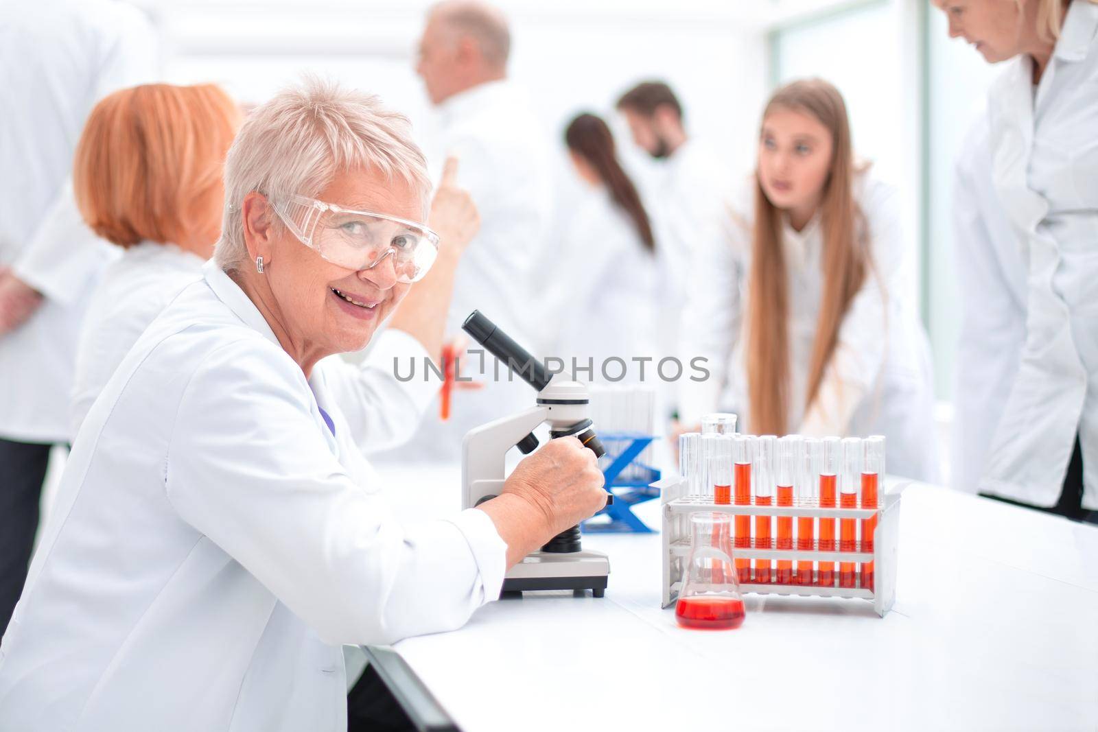 female scientist sitting at a Desk in the laboratory. by asdf