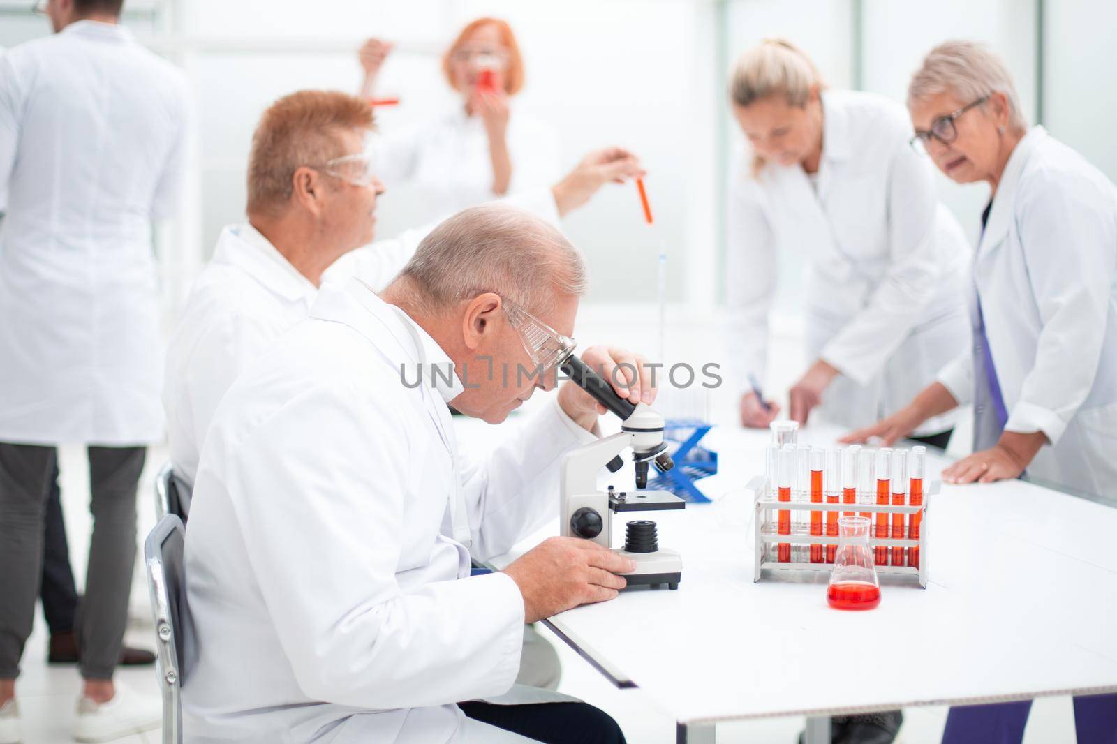 group of scientists conduct testing in the laboratory . by asdf