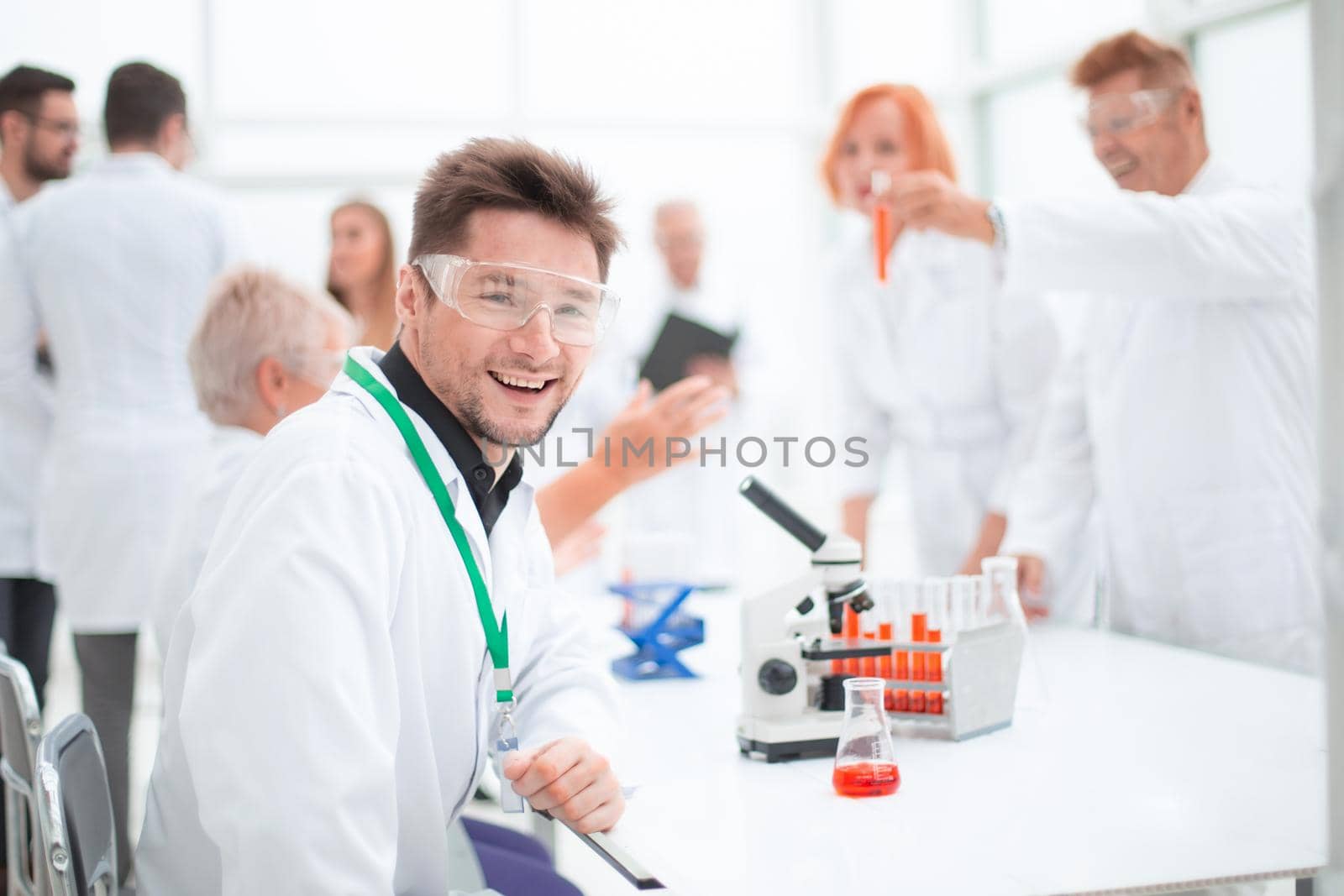 young scientist looking at a test tube with test results. concept of health protection.