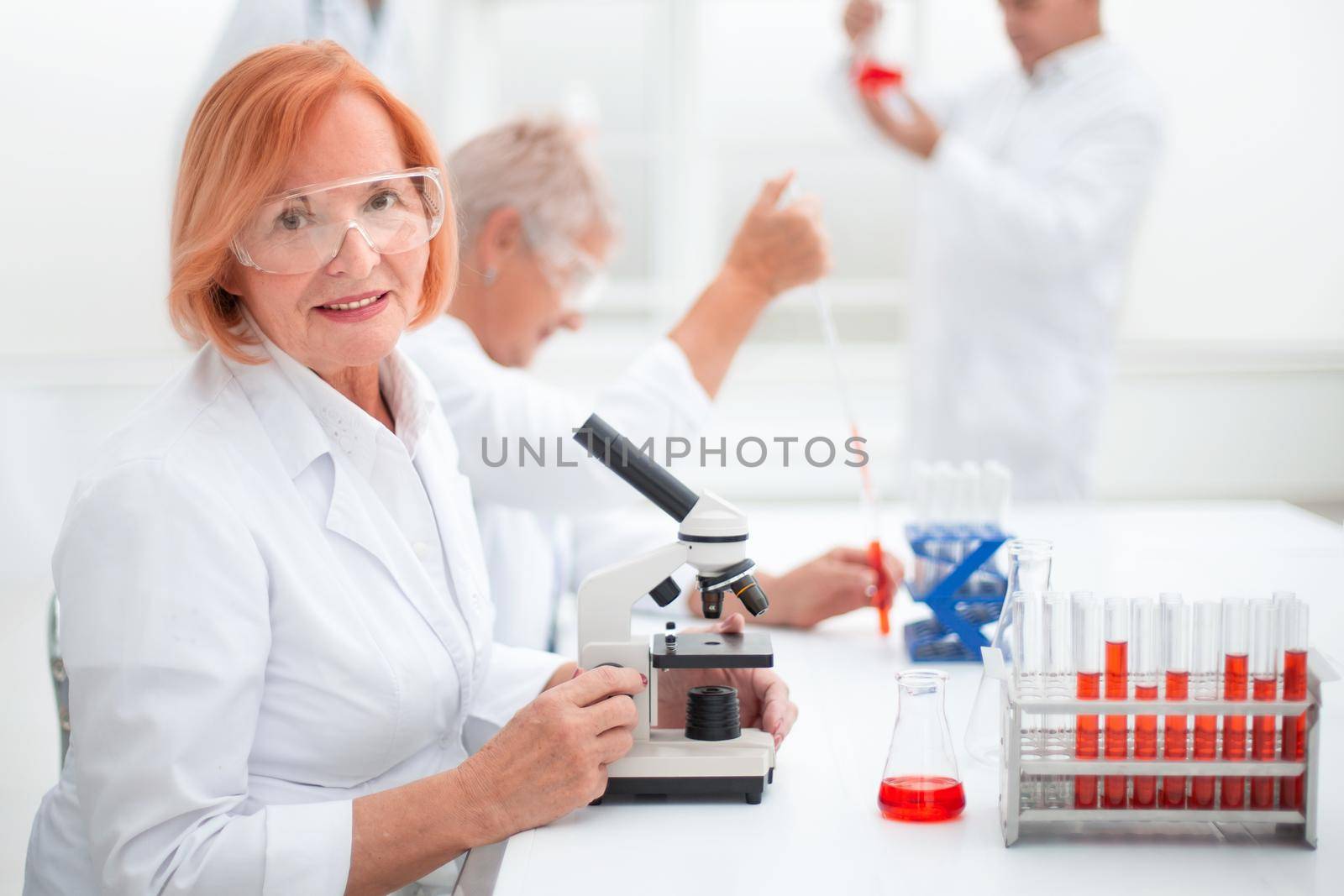 female scientist conducts a blood test in the laboratory. by asdf
