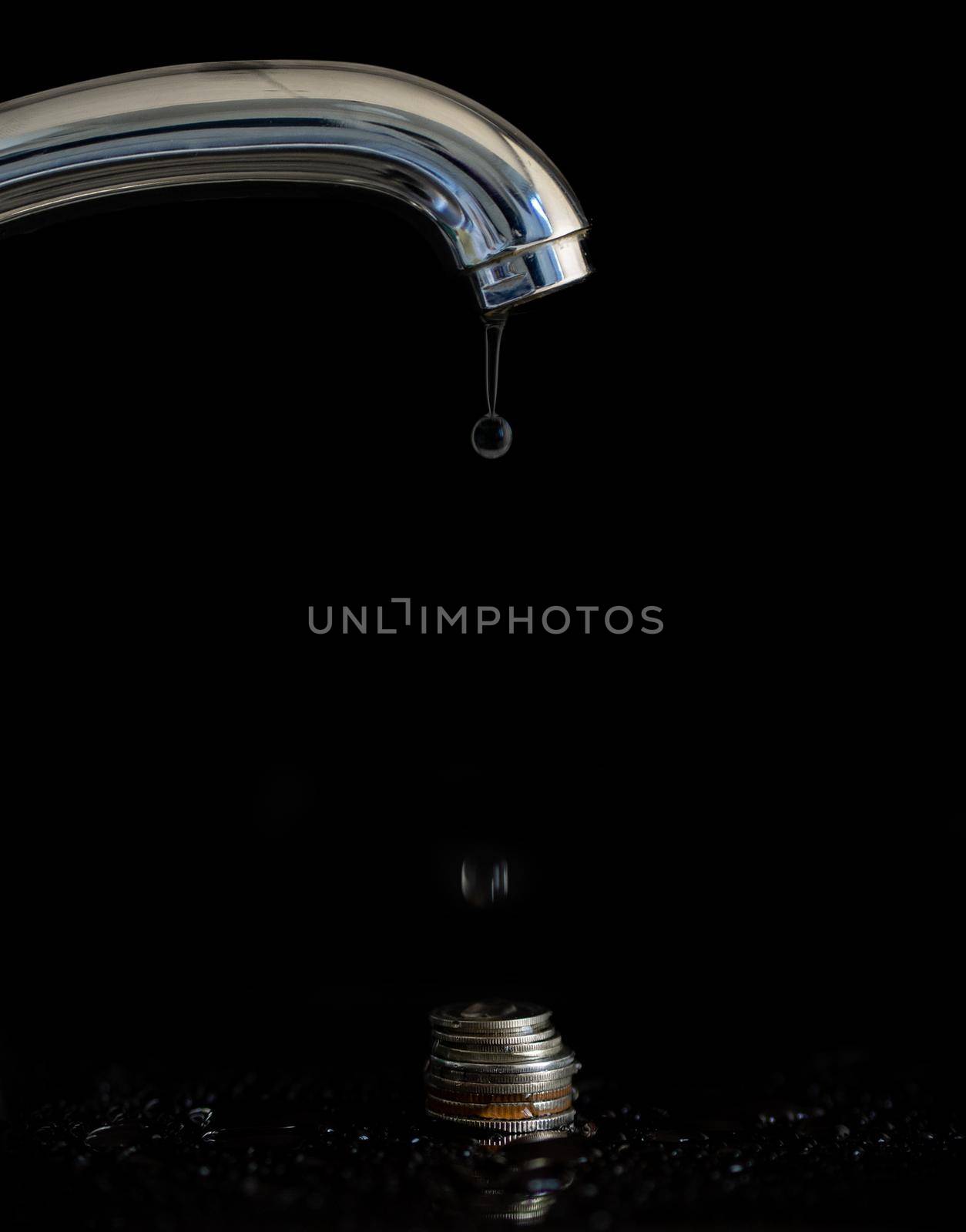 Water dripping from a faucet for money