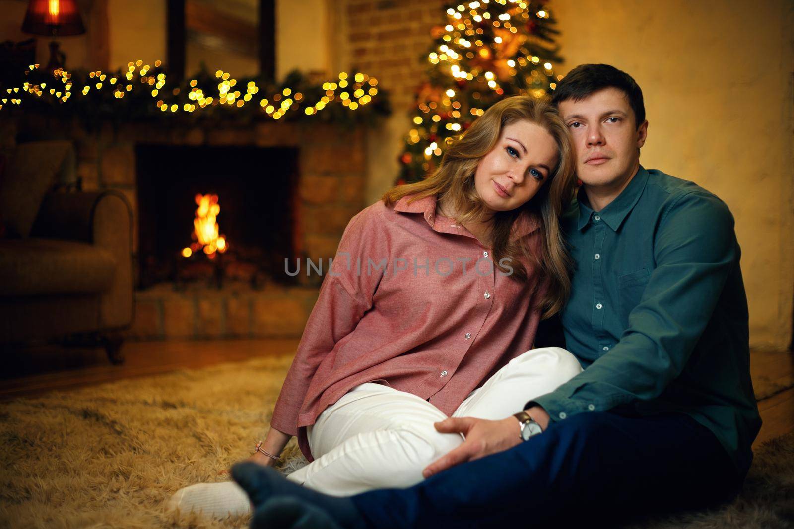 Beautiful middle aged couple posing in christmas interior by Rom4ek