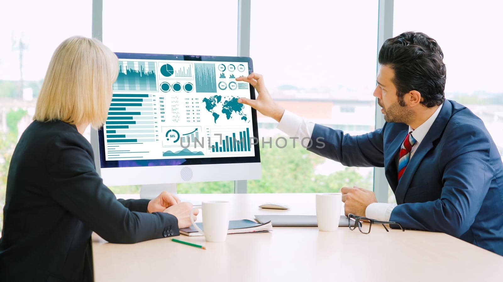 Business data dashboard analysis by ingenious computer software . Investment application display business sales and profit on the computer screen and advise marketing planning decision .