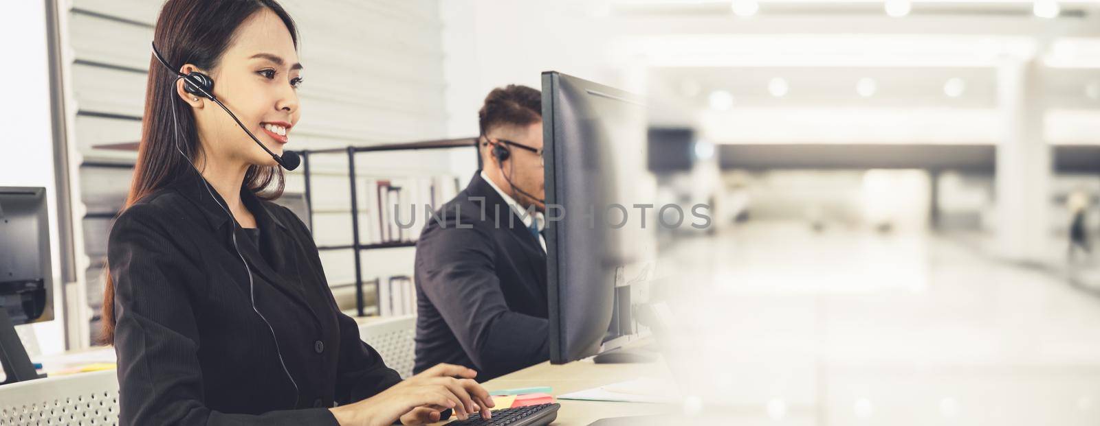 Business people wearing headset working in office to support remote customer or colleague. Call center, telemarketing, customer support agent provide service in broaden view .