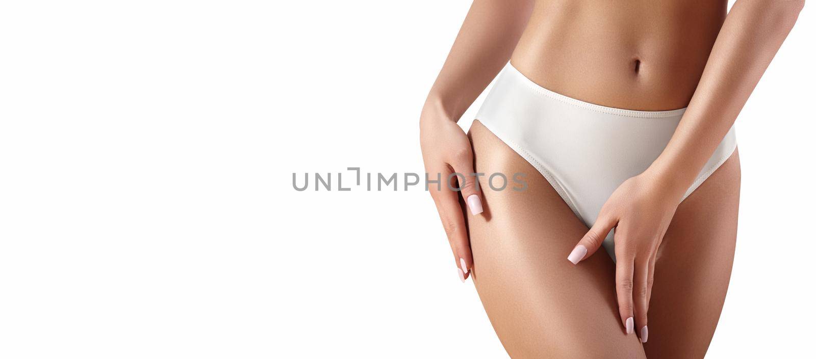 Spa and wellness. Healthy slim body in white panties. Beautiful sexy hips with clean skin. Fitness or plastic surgery. Perfect buttocks without cellulite.