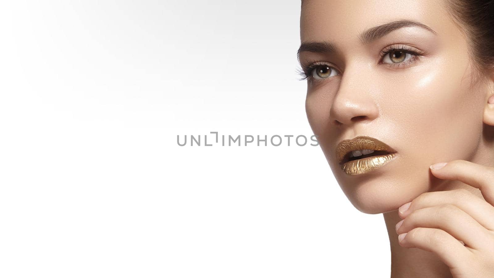 Young Beautiful Woman with clean soft Skin, bright gold Lips Makeup. Perfect eyebrows shapes. Day make-up by MarinaFrost