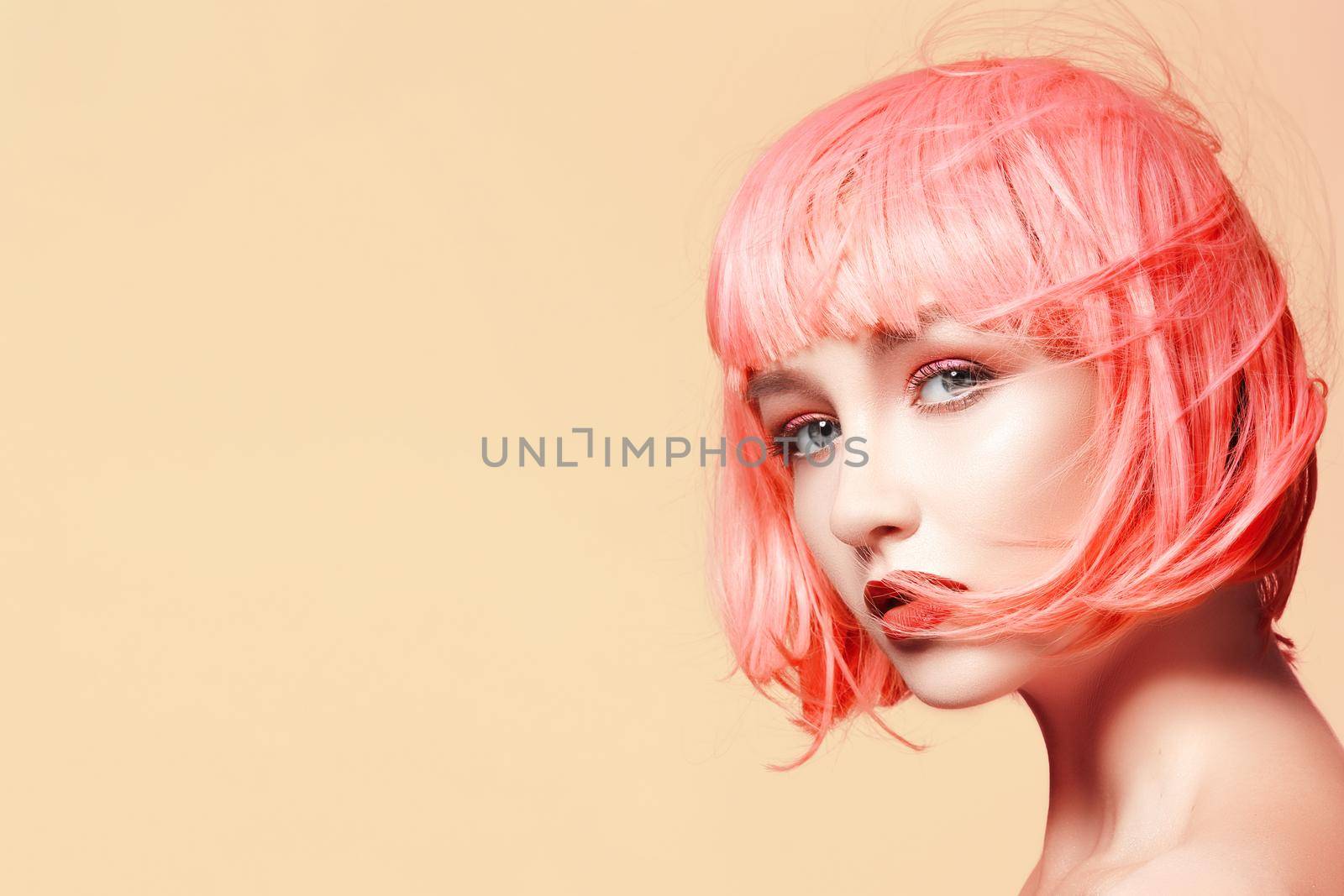 Young woman in pink wig. Beautiful model with fashion makeup. Bright spring look. Sexy hair color, medium hairstyle by MarinaFrost