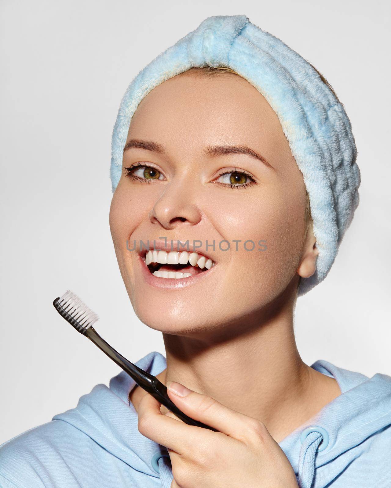 Beautiful Woman in Headband with Great Teeth holding Tooth Brush. Daily Routine Teethcare Treatment for Happy Smile by MarinaFrost