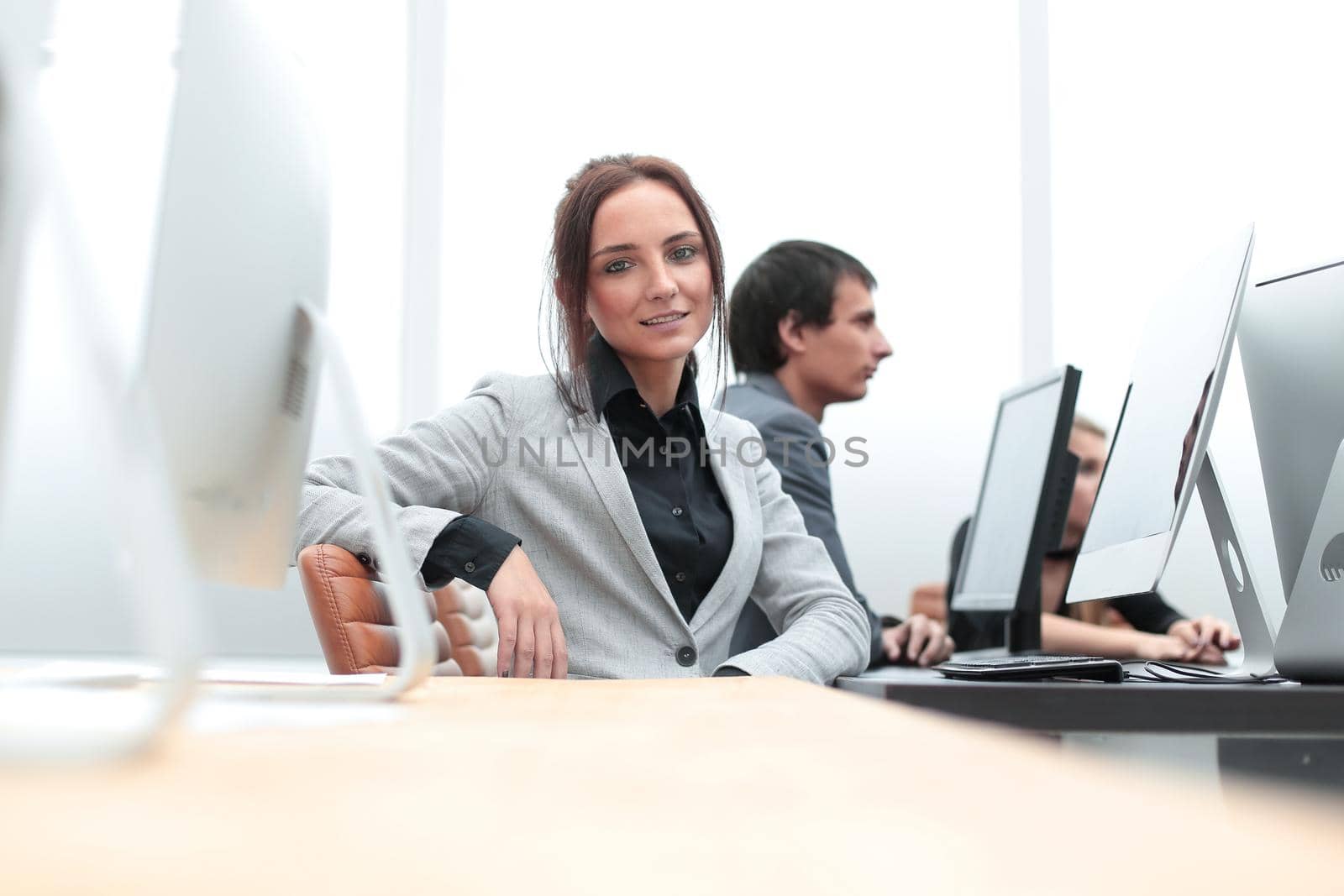 young woman is working on a computer in the office. business people