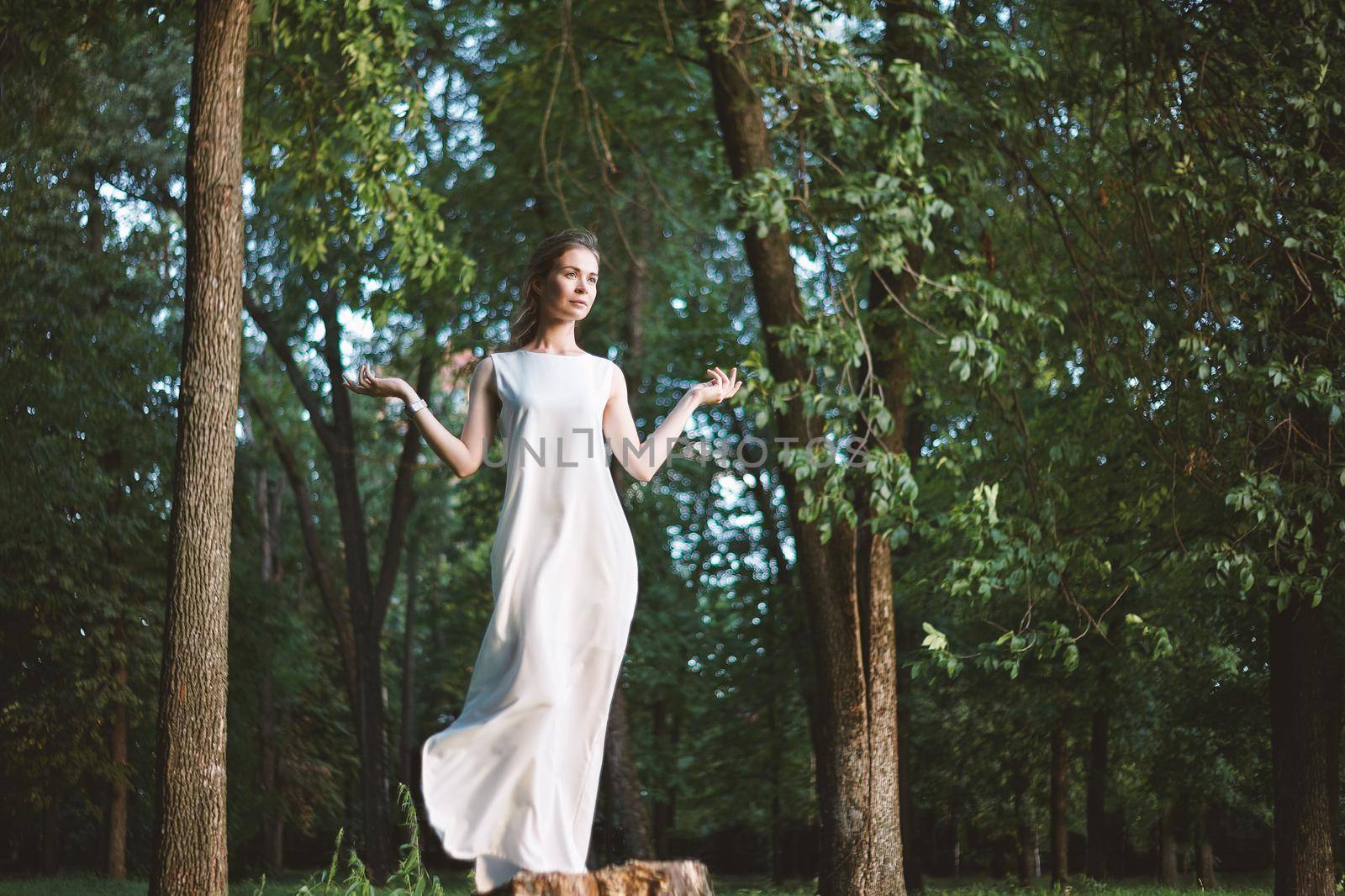 Beautiful Woman Posing like Goddess in White Long Dress at Nature. Boho Style, Soul Calm, Wellness. Freedom and Relaxing by MarinaFrost