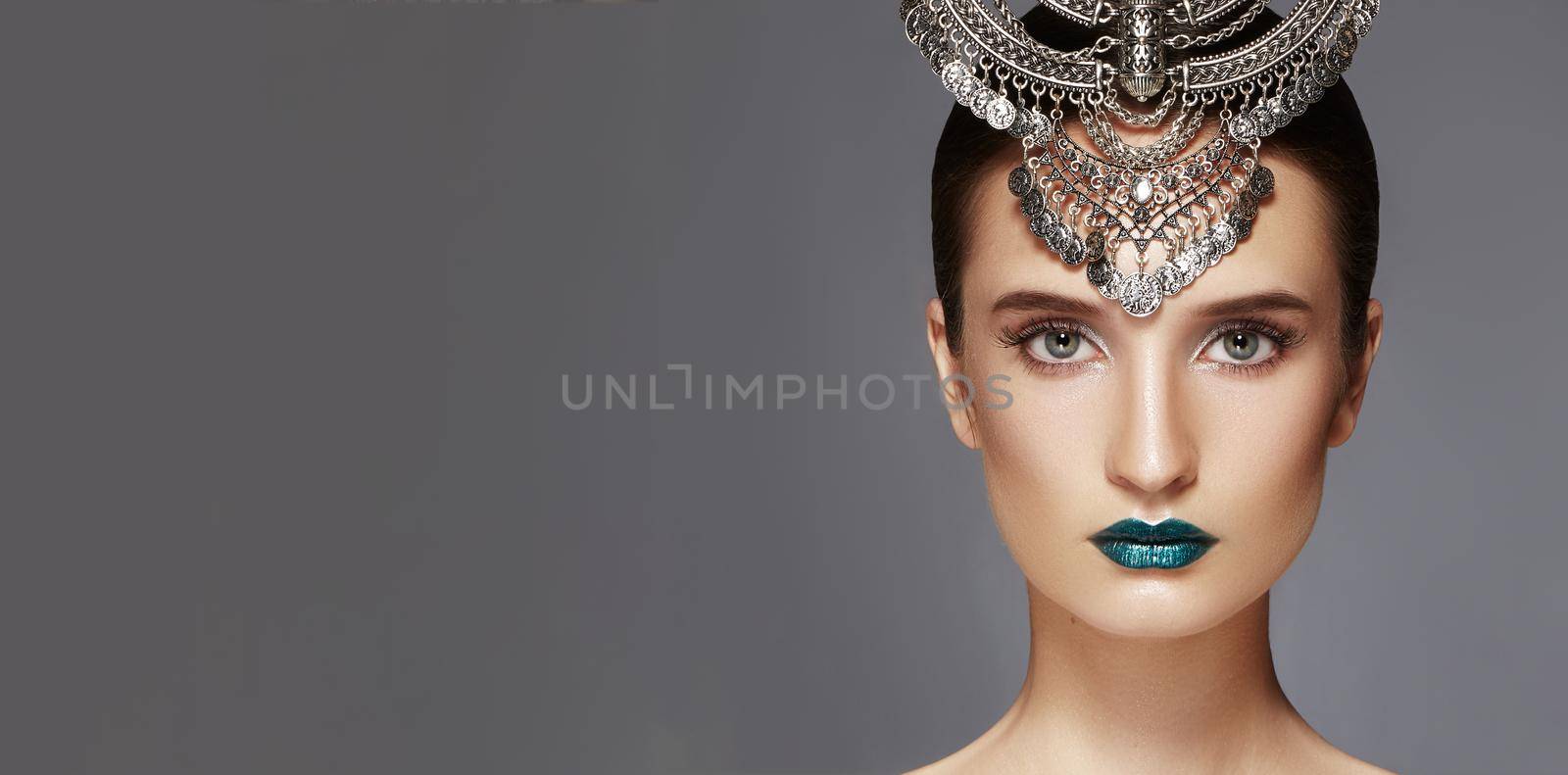 Beautiful Woman with Silver Diadem. Modern Indian Fashion Style. Jewelry Luxury Accessories. Bright Make-up, sexy metallic Lips