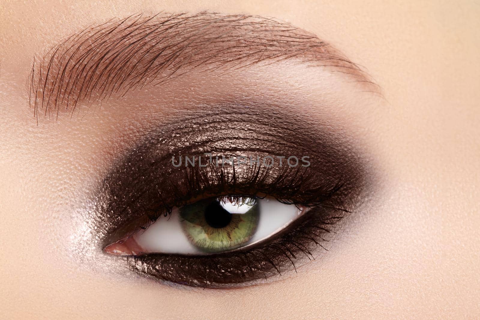 Beauty, cosmetics and makeup. Elegant classical smoky make-up on female eyes. Beauty, cosmetics and makeup. Dark brown eyeshadow make-up, glamour evening style