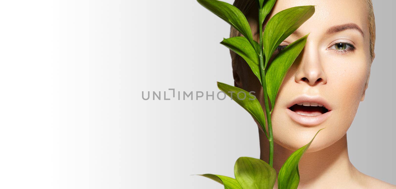 Beautiful Woman applies Organic Cosmetic. Spa and Wellness. Model with Clean Skin. Healthcare. Picture with Leaf by MarinaFrost