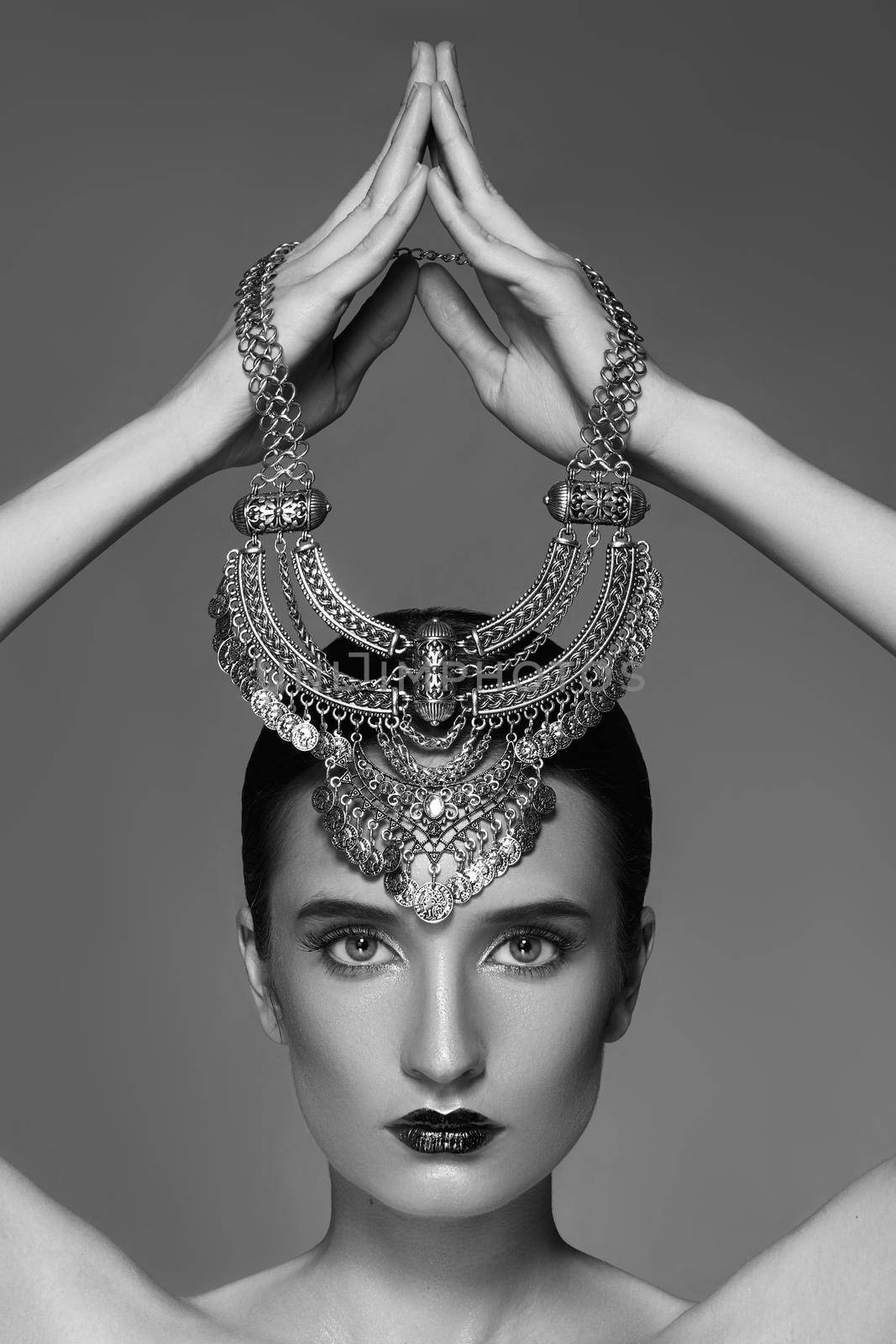 Beautiful Woman with Silver Necklace in hand over head. Retro Indian Fashion Style. Jewelry Luxury Accessories. Black and White Photo