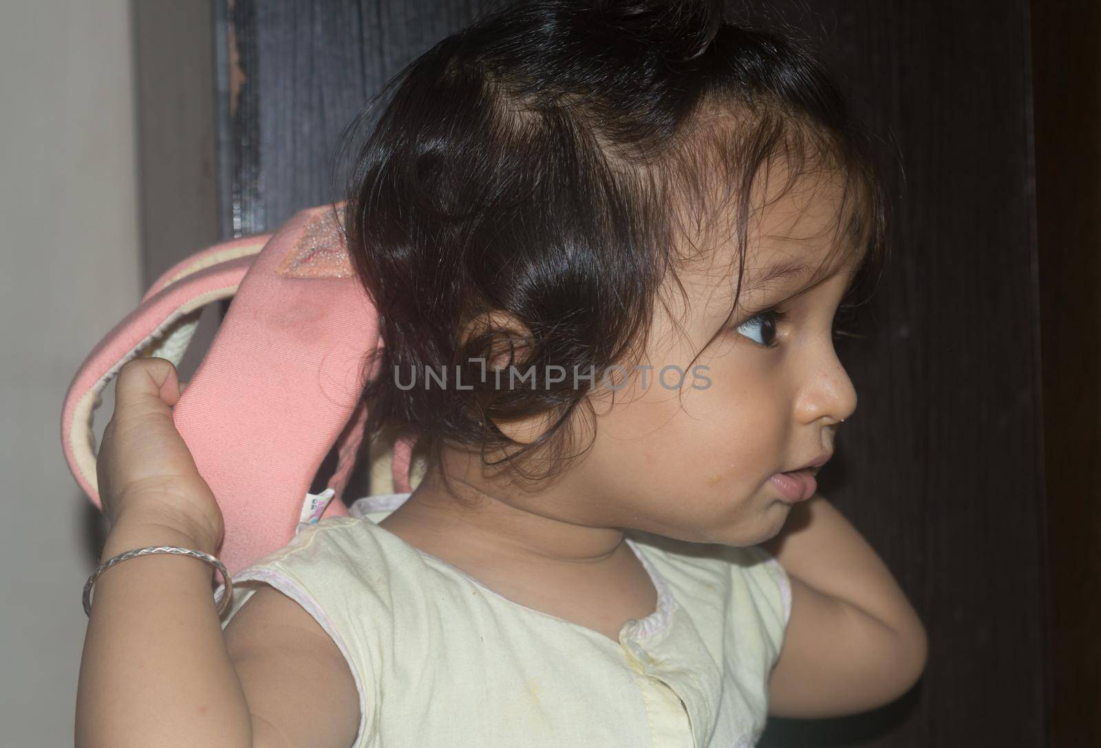 Cute Indian baby boy in funny mood posing smiling and away from camera. by sudiptabhowmick