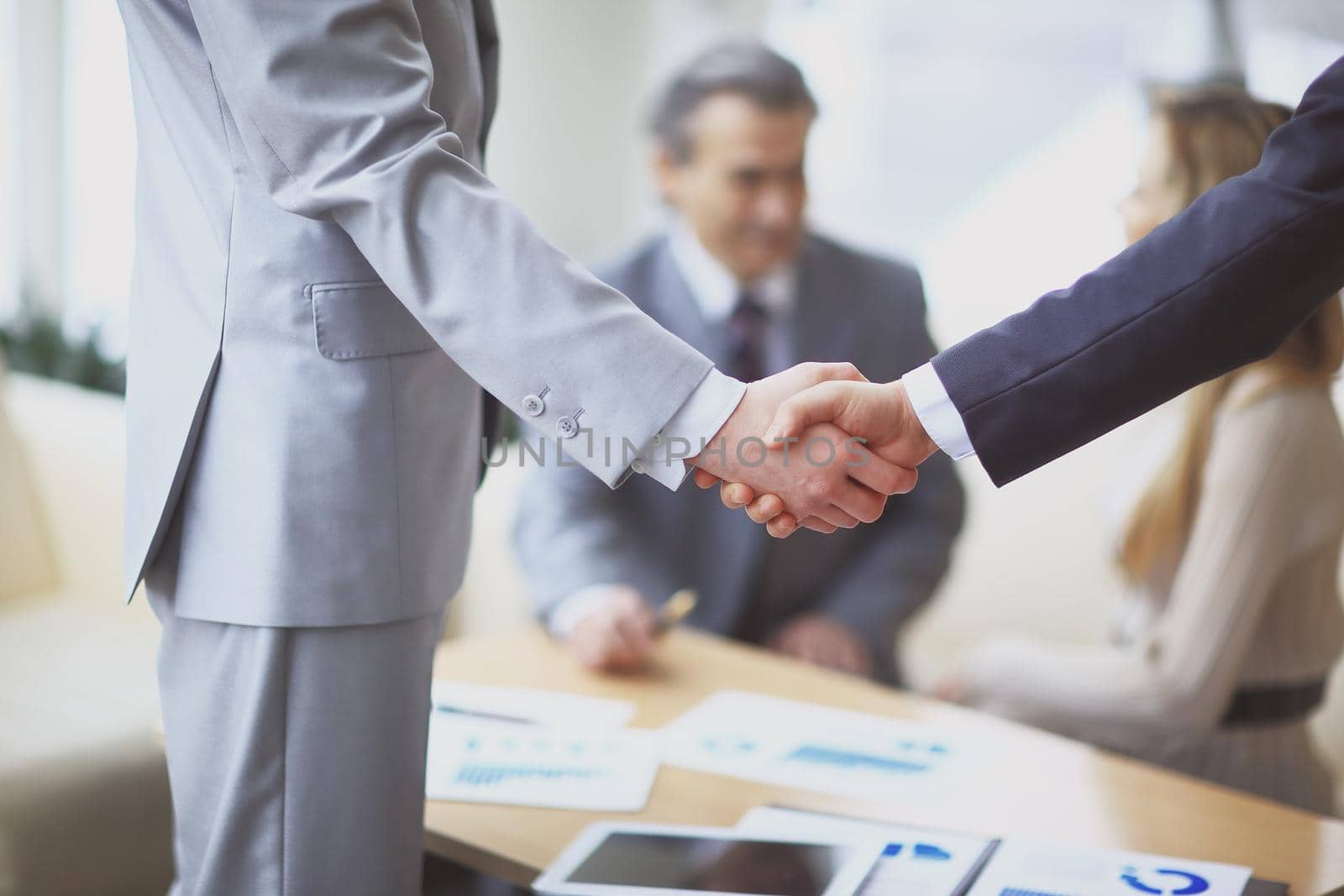 close up.handshake of business partners on the background of the workplace.