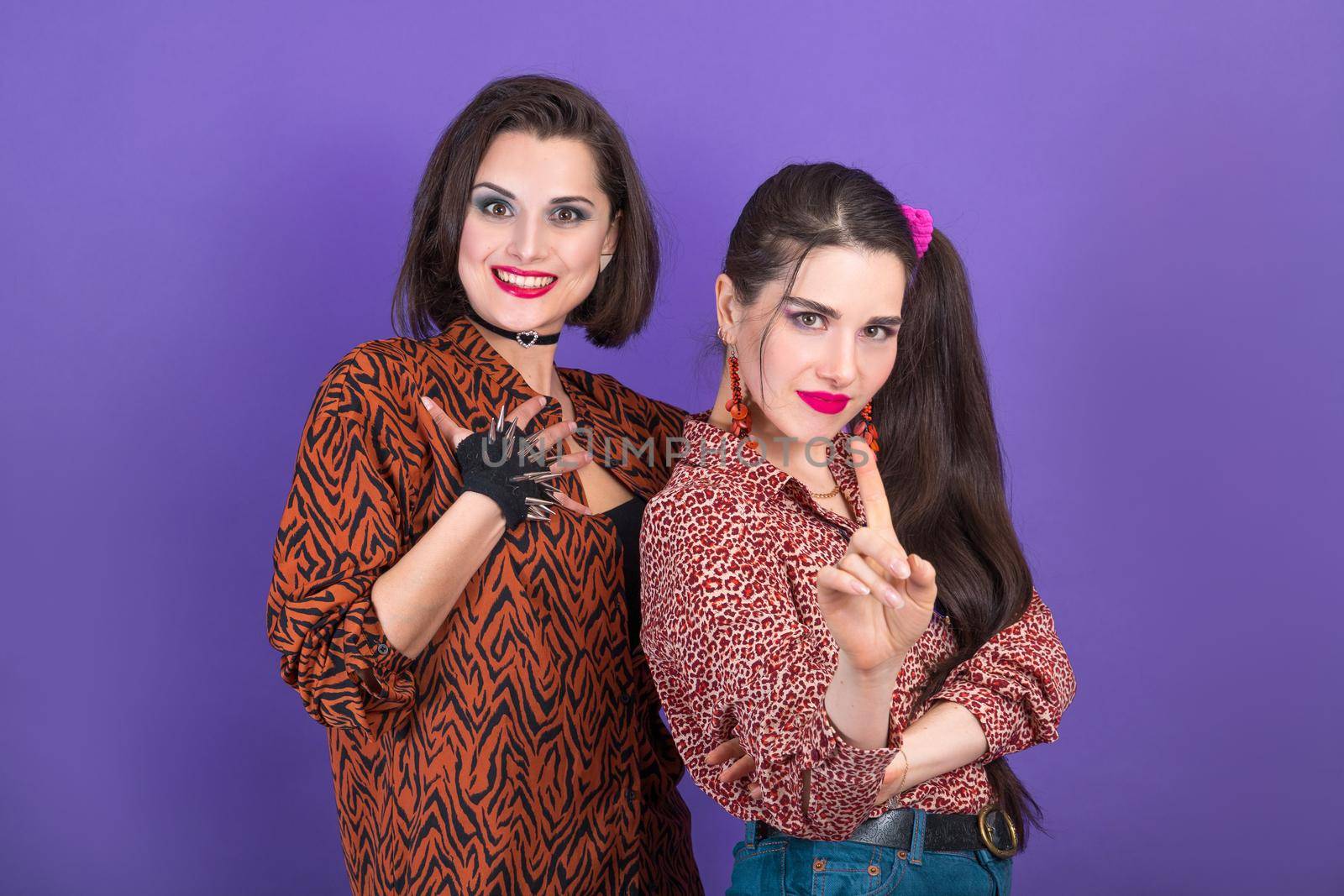 Party in retro 80s style. Two young women on blue background.