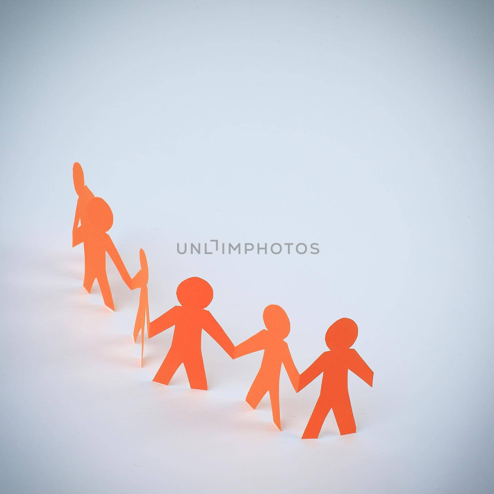 three teams paper men taking each other's hands by SmartPhotoLab