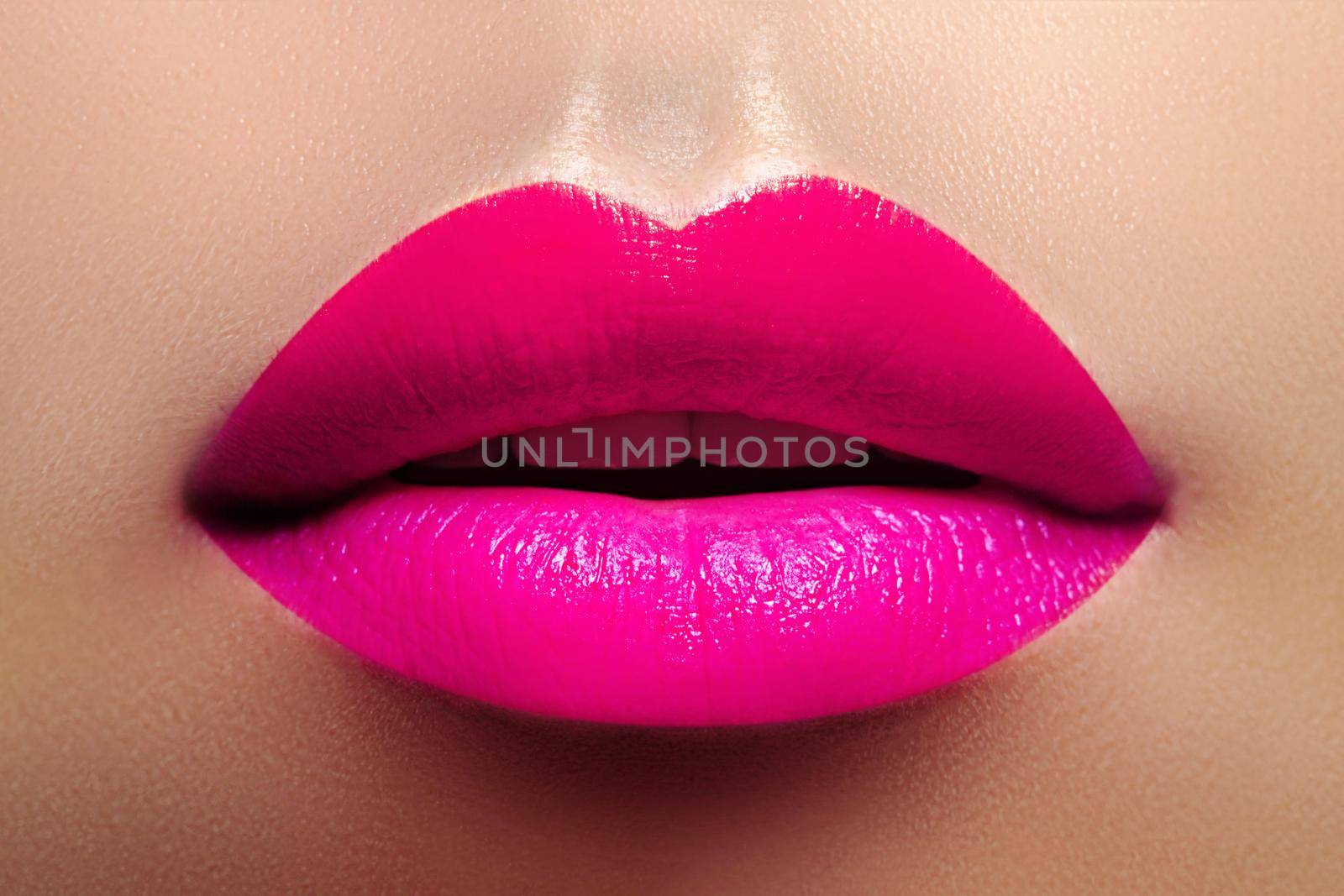 Cosmetics, Makeup. Bright Lipstick on Lips. Closeup of Beautiful Female Mouth with Fashion Pink Lip Makeup. Part of face by MarinaFrost
