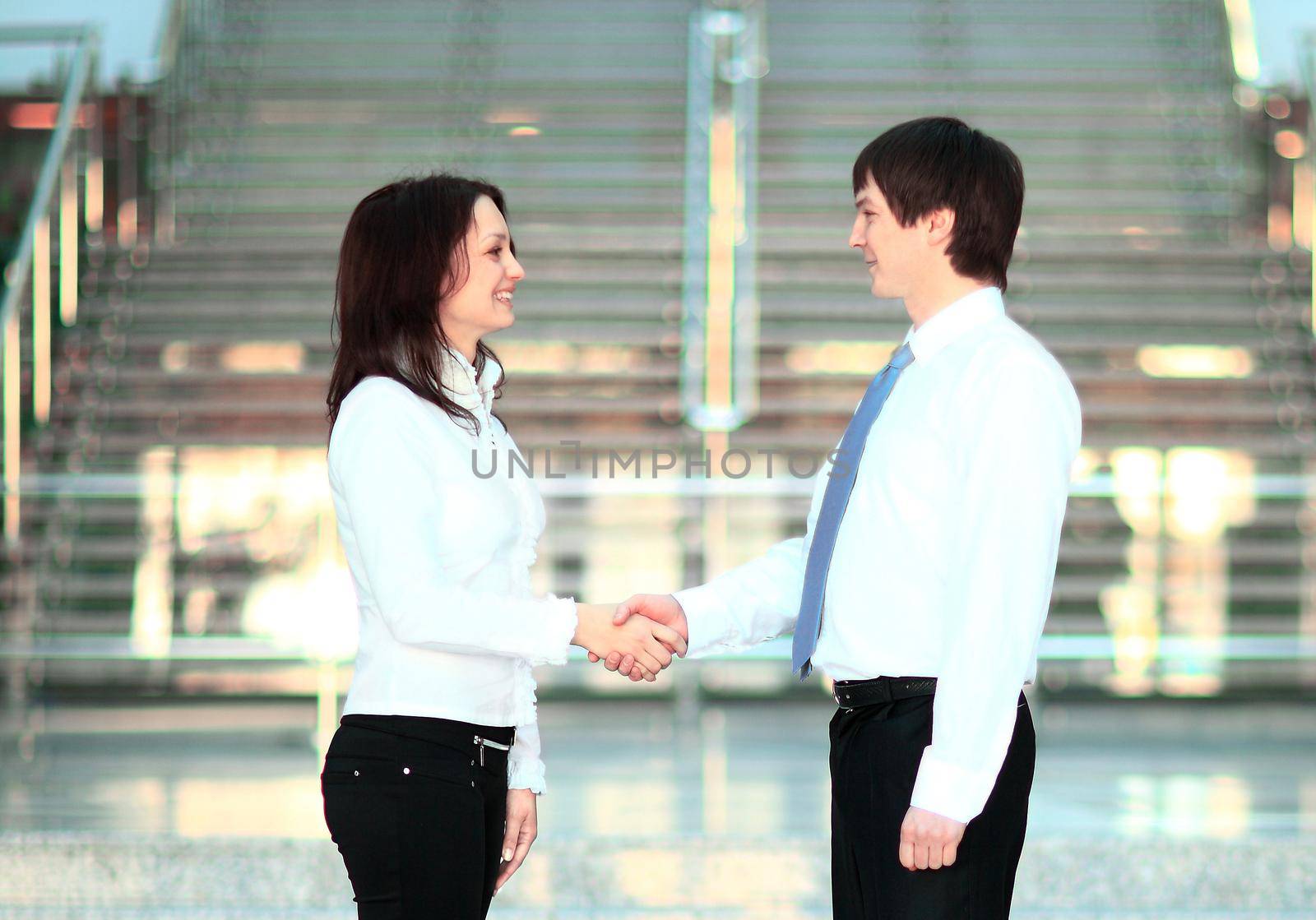 businesswoman and client handshaking by SmartPhotoLab