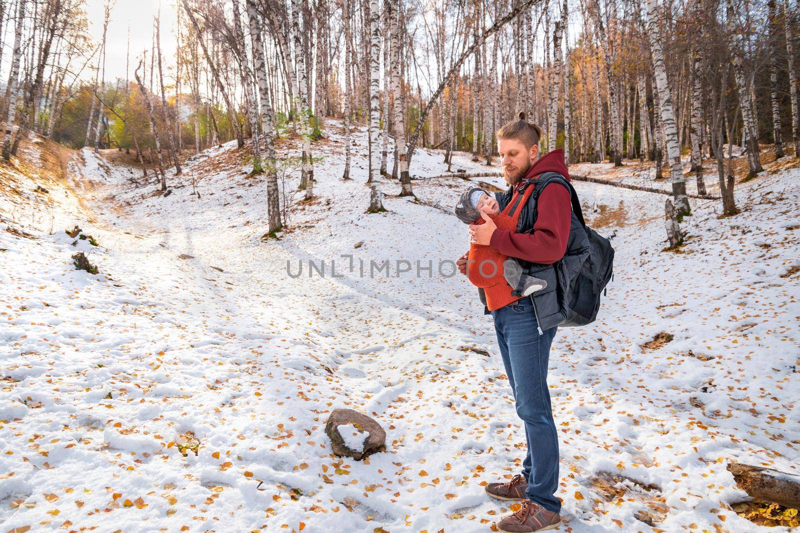 Young father hipster with his baby spend time fall forest outdoor.