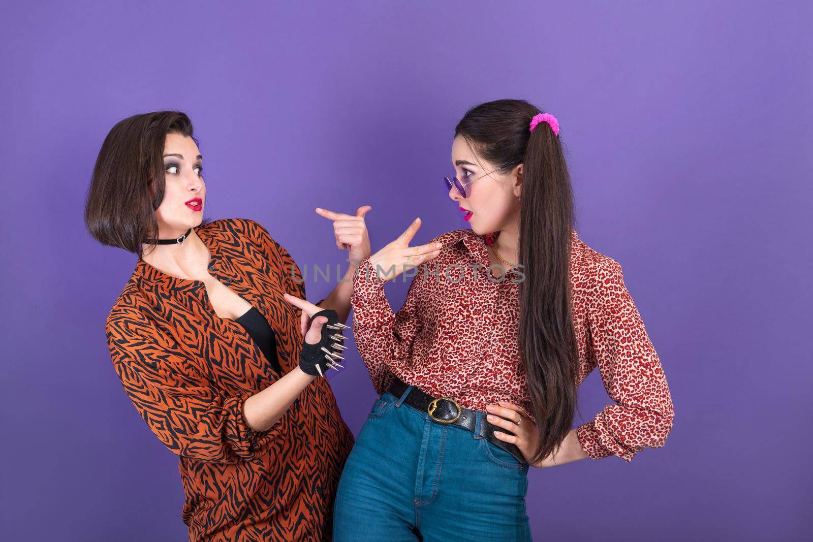 Two cute young women dressed in 90s style fooling around on purple background by Rom4ek