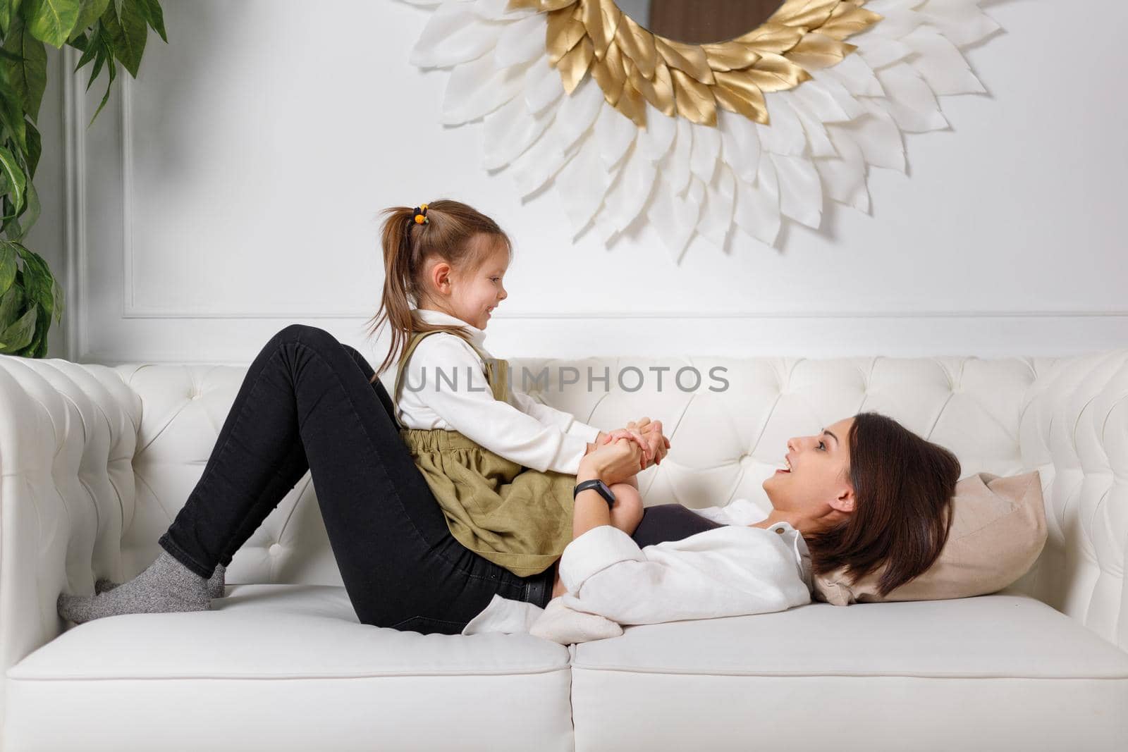Young mother with her kid girl spend time together at home.