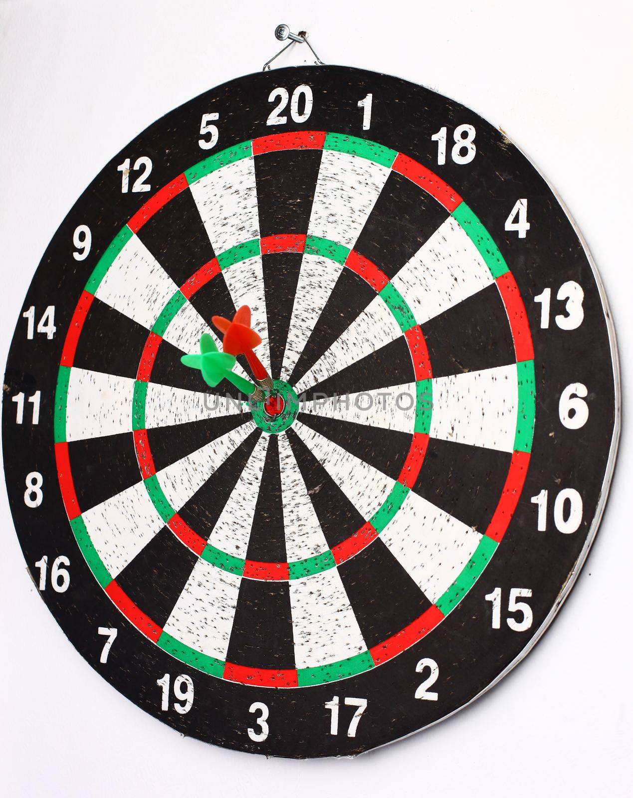 closeup. several Arrows dart hitting the center of the target dart Board.the concept of purpose.