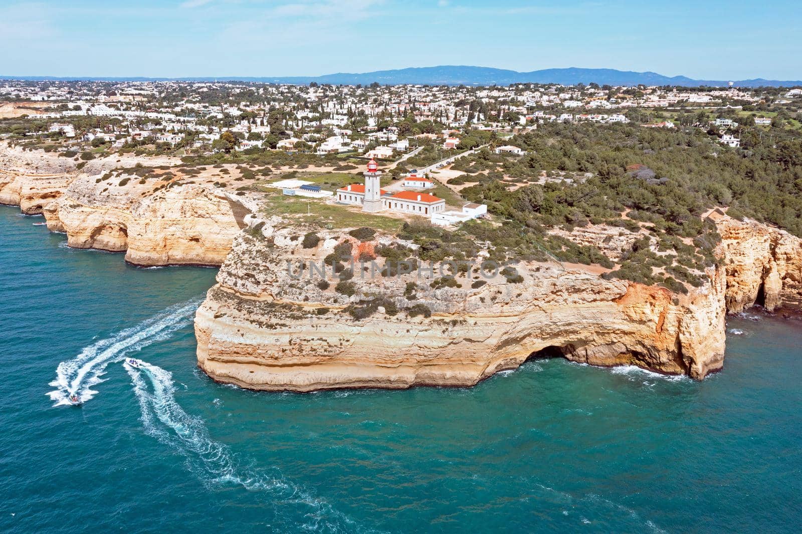 Aerial from lighthouse farol de Alfanzina on a cliff in the Algarve Portugal by devy