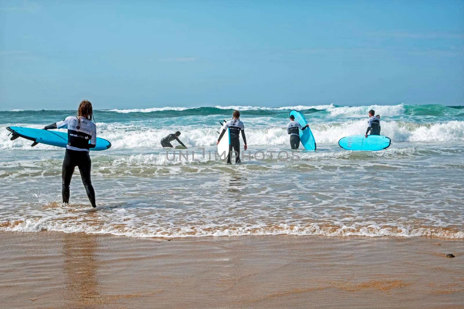 VALE FIGUEIRAS, PORTUGAL - March 29, 2022: Surfers getting surfers lessons at the atlantic ocean in Portugal by devy