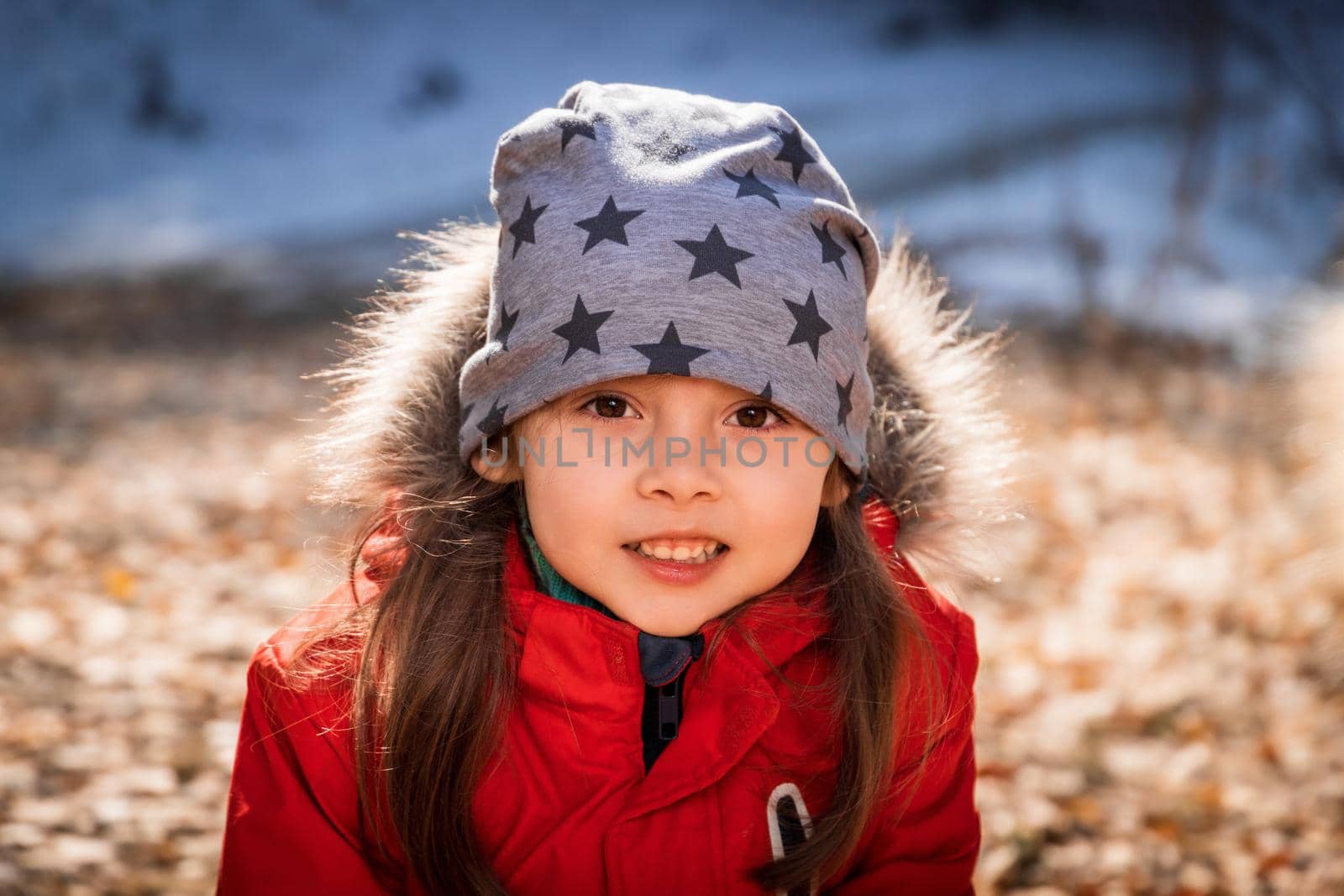 Outdoor portrait of 5 y.o. girl in autumn sunny day.