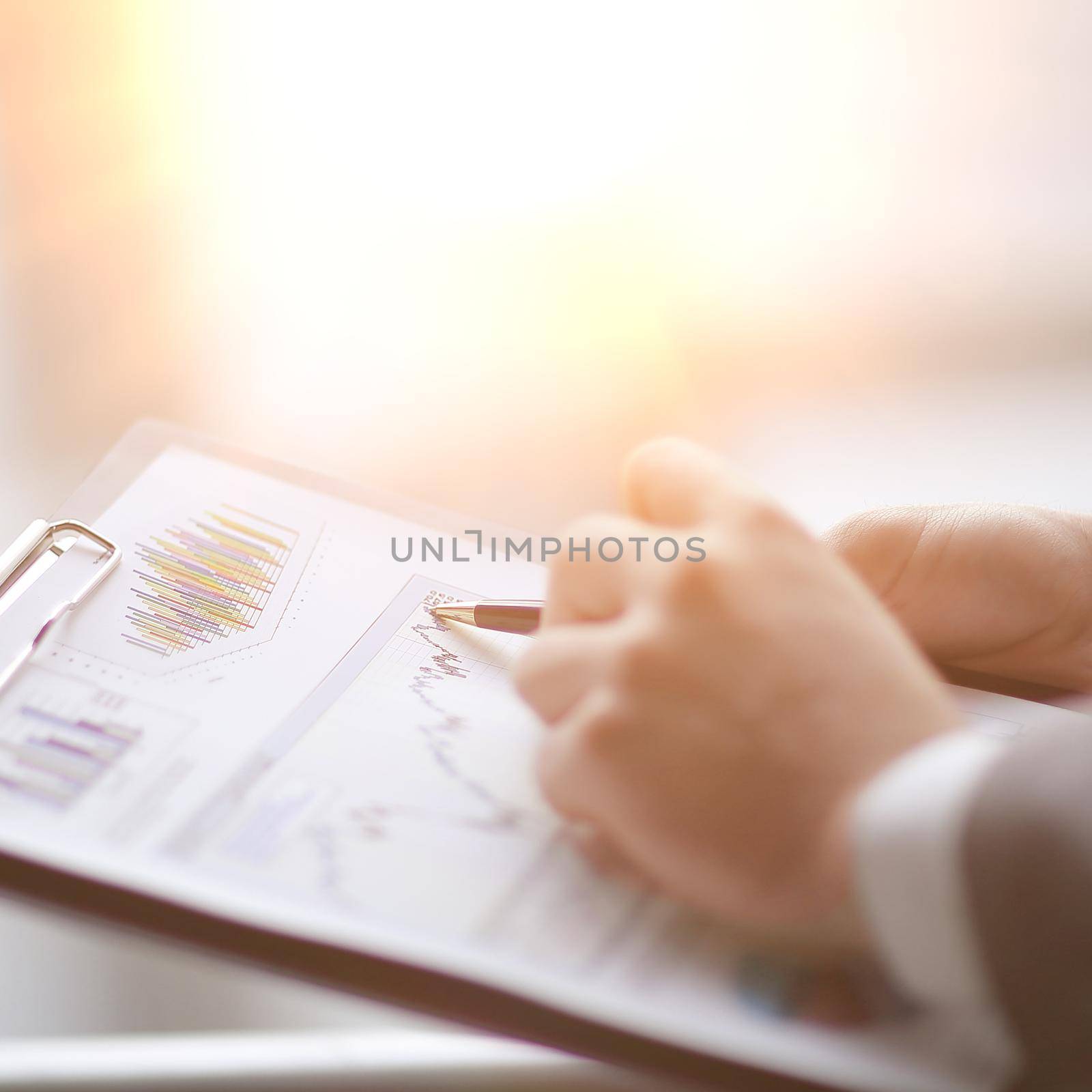 close up.businessman checking sales schedule.photo on blurred background by SmartPhotoLab