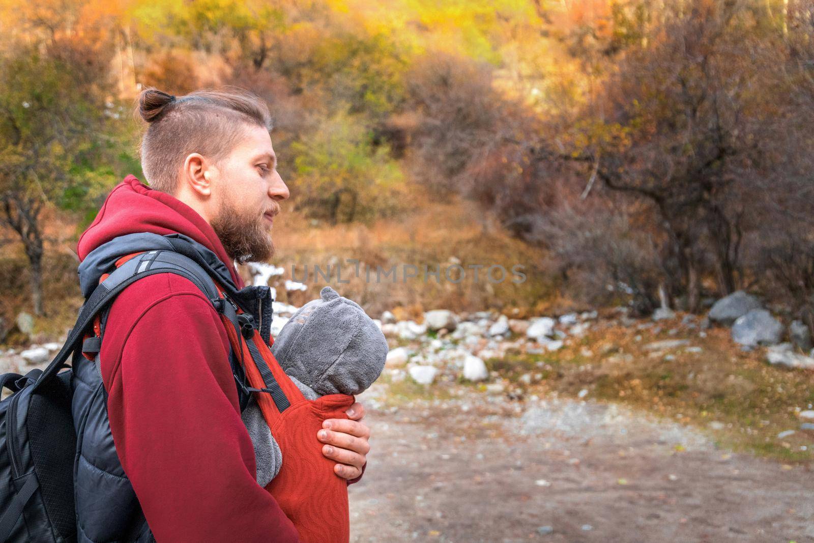 Young father hipster with his baby spend time autumn outdoor. copy space