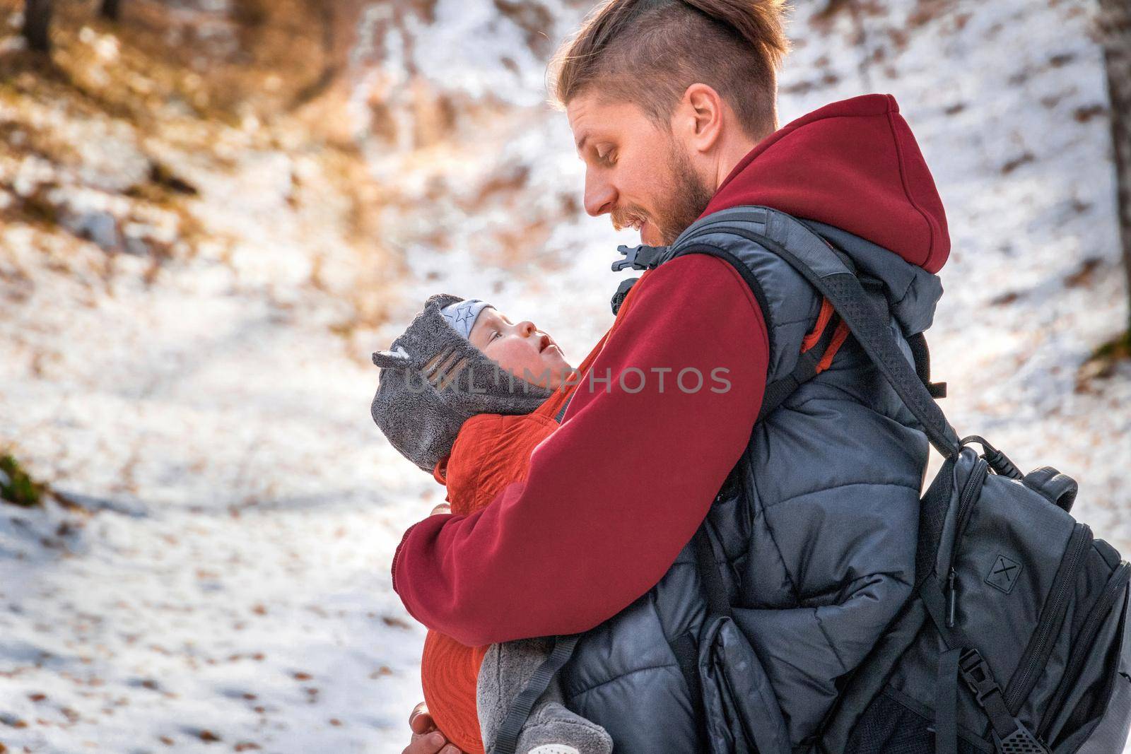 Lifestyle portrait of father an his baby son while walking outdoor.