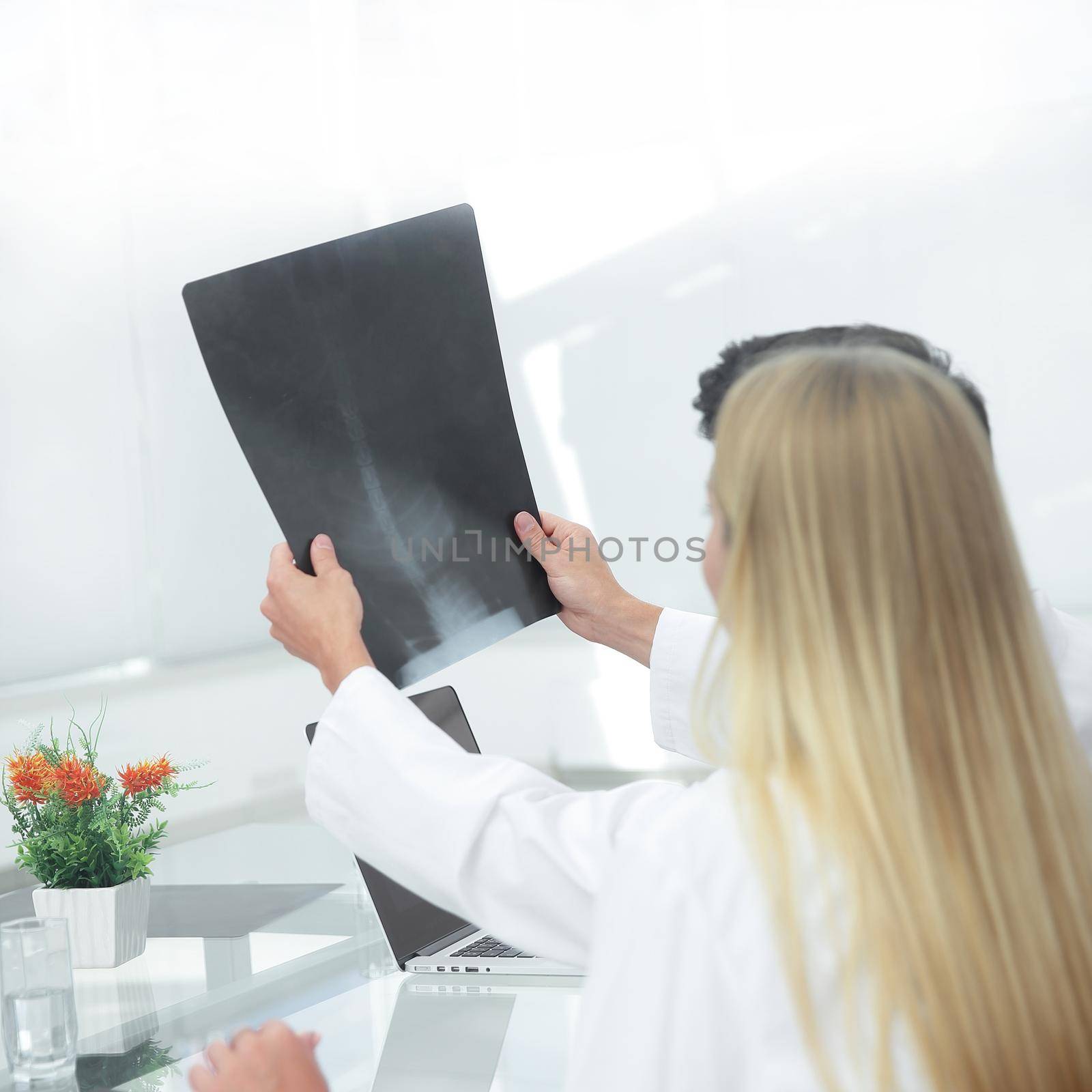 close up.the doctor shows his patient an x-ray.