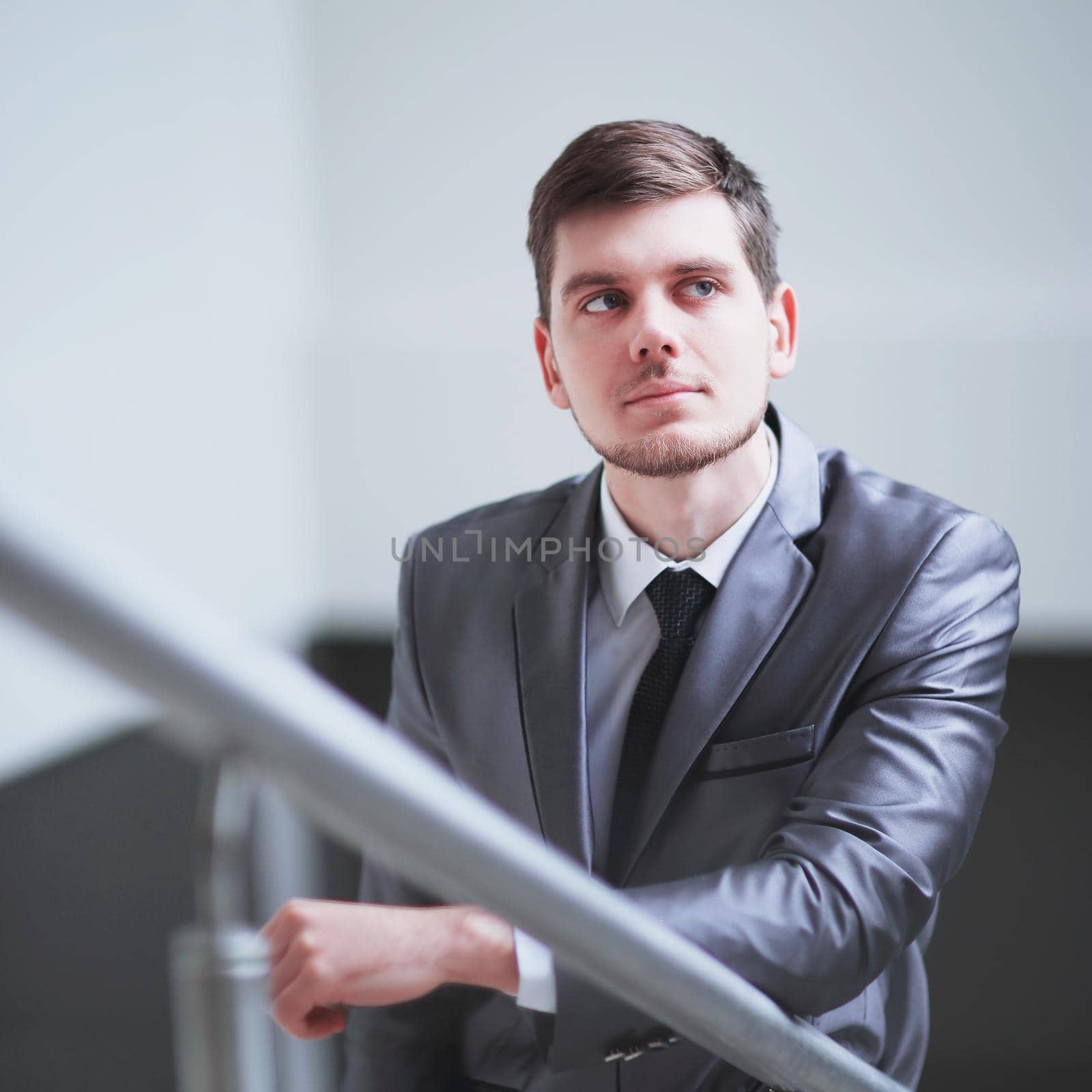 close up.thoughtful businessman looking out the office window by SmartPhotoLab