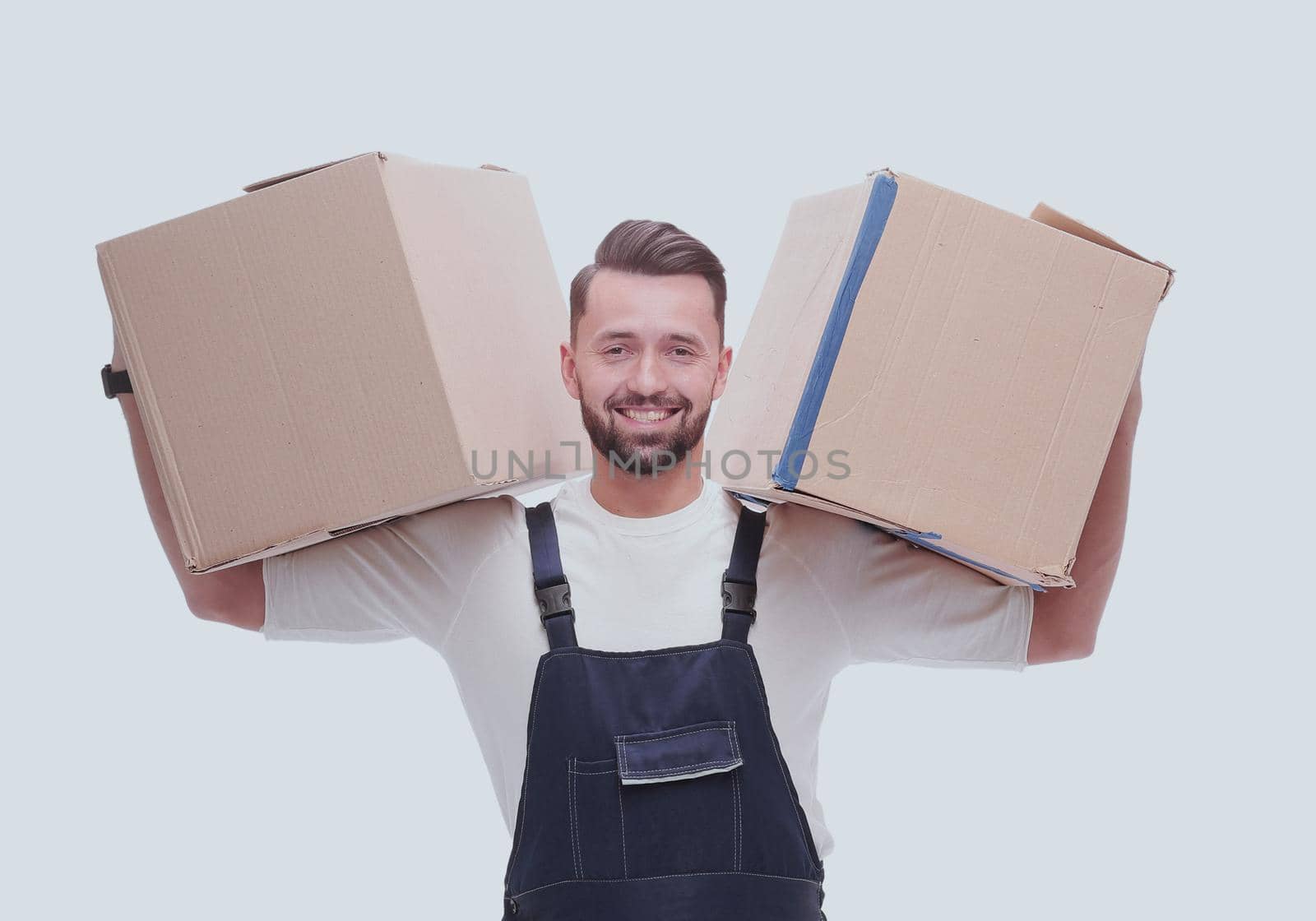 smiling man with cardboard boxes on his shoulders. isolated on white