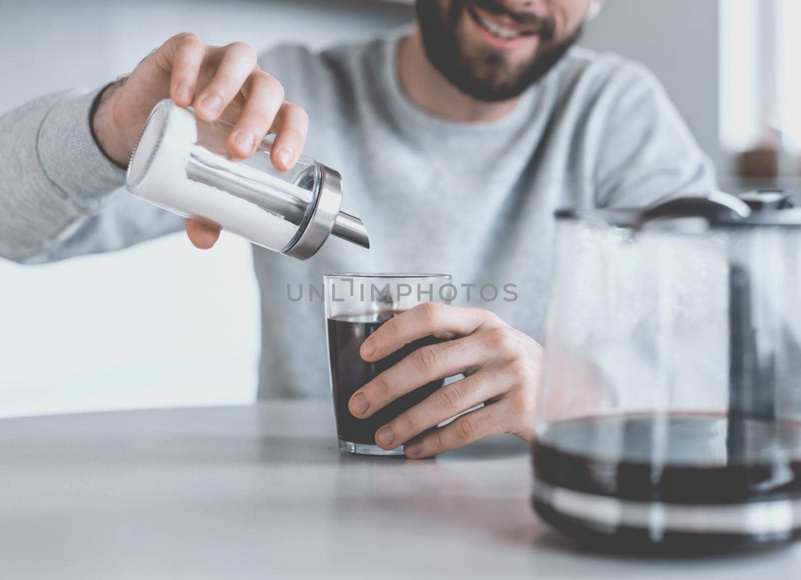 close up. sugar container with a dispenser in the hands of a man. photo with copy space